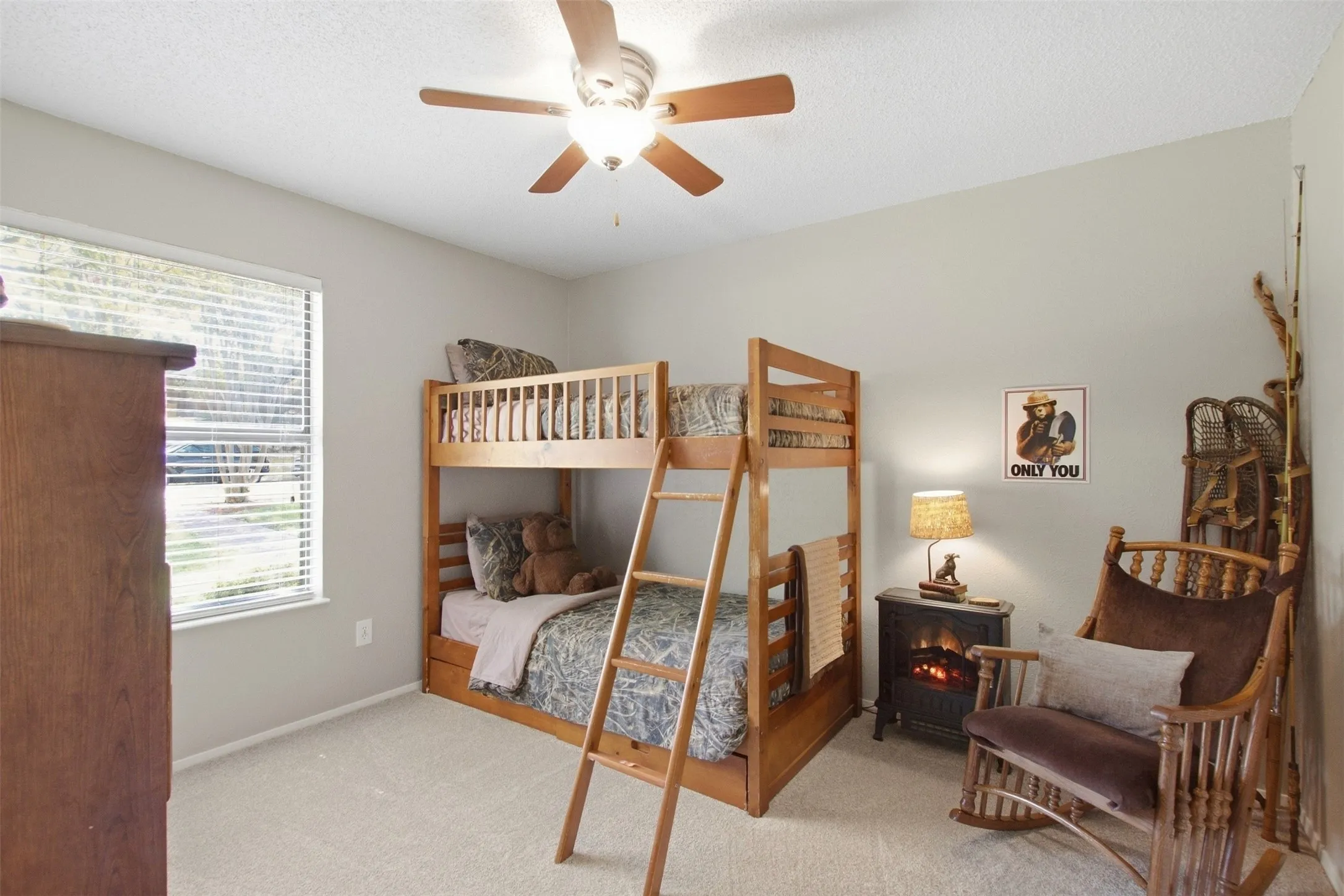 Carpeted room featuring a ceiling fan with light, a window with blinds, and light-colored walls