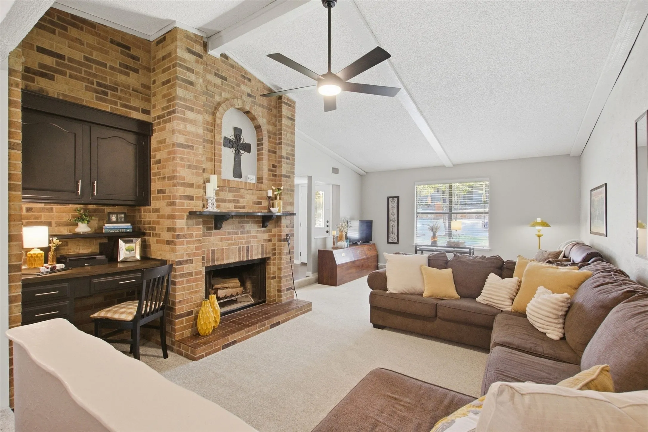 Brick accent wall with an arched fireplace and hearth
