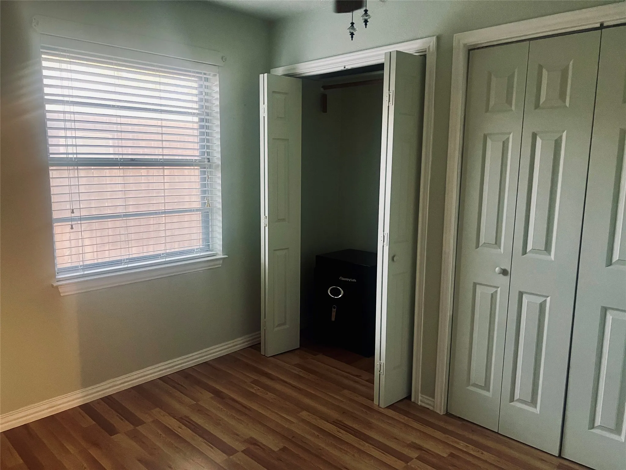 Bedroom with built in safe in closet