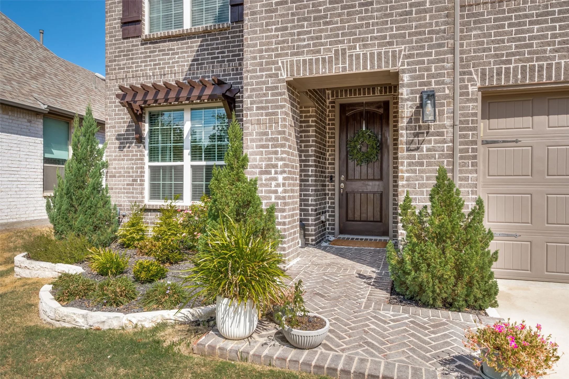 Brick exterior with stone-lined landscaping