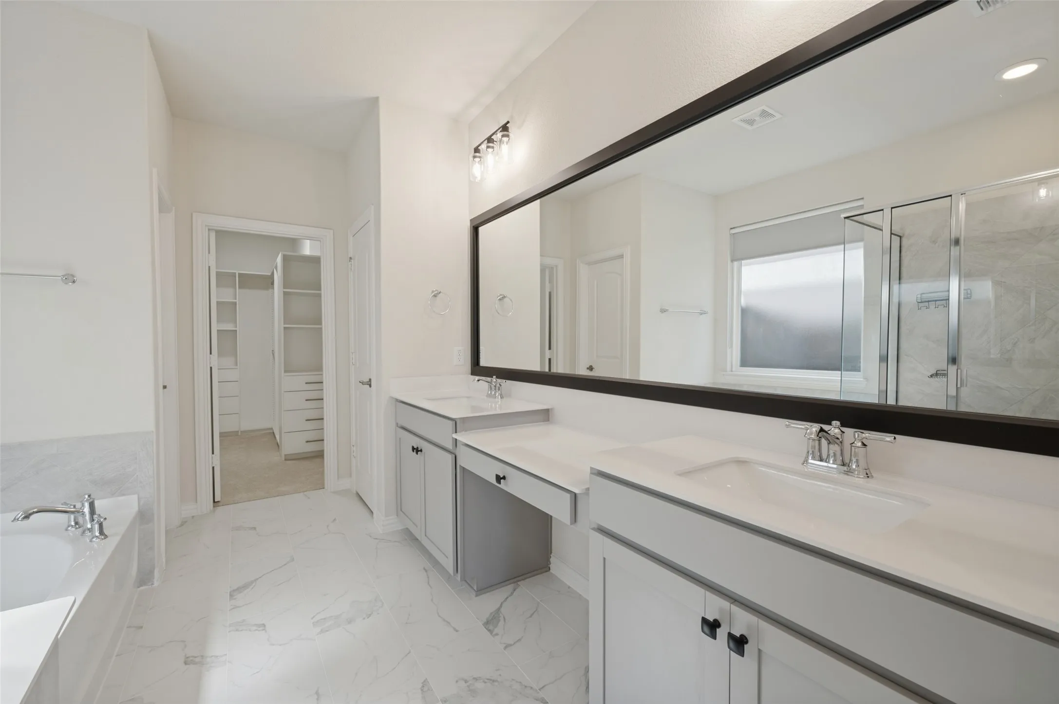 Dual vanity with undermount sinks and light-toned countertops