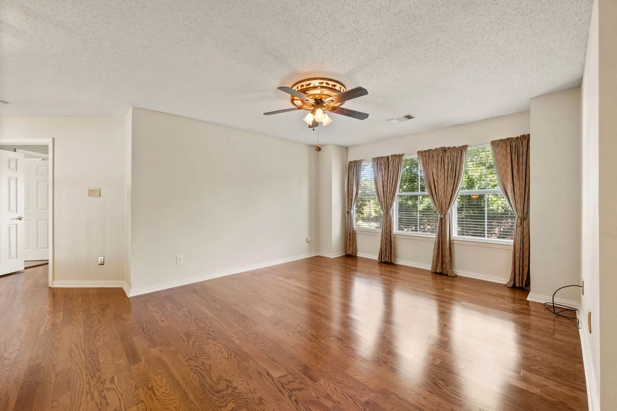 Hardwood flooring, recessed lighting, and a ceiling fan with integrated lighting