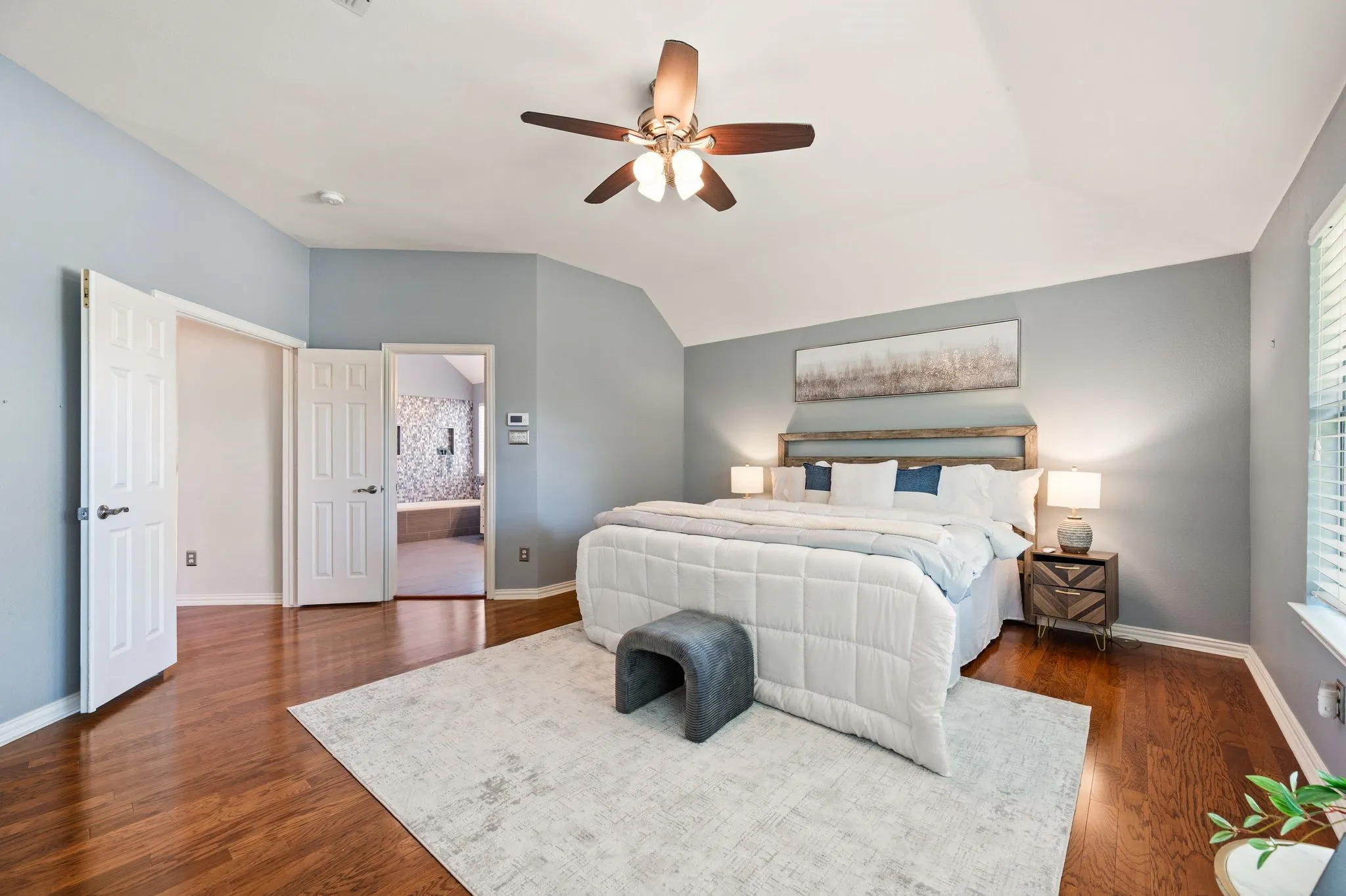 Hardwood-finish flooring, vaulted ceiling, and ceiling fan