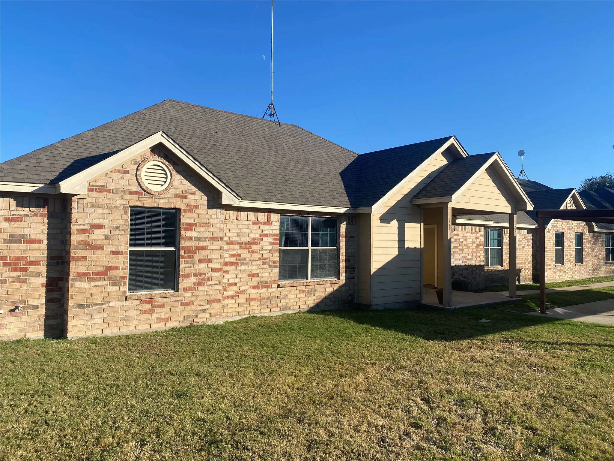 Brick and siding exterior with a covered entry