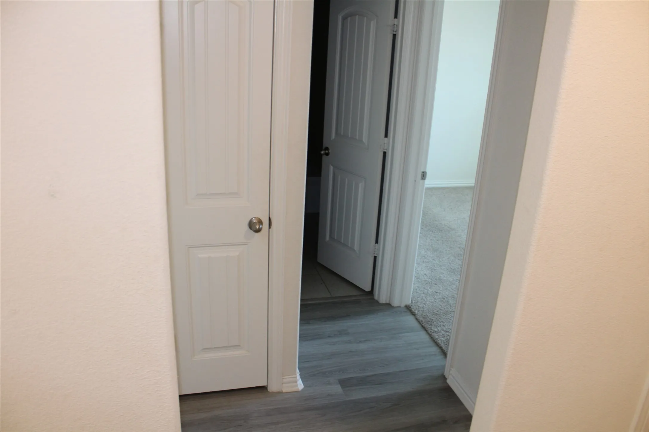 Recessed panel interior doors, wood-finish flooring, and light-toned wall finishes