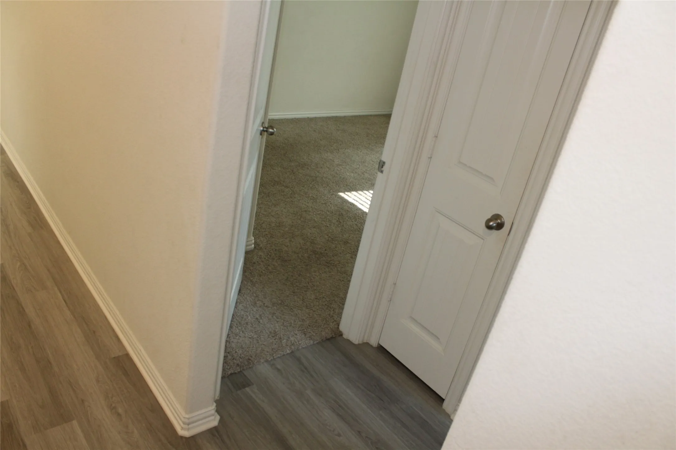 Light wood-finish plank flooring and white wall finishes