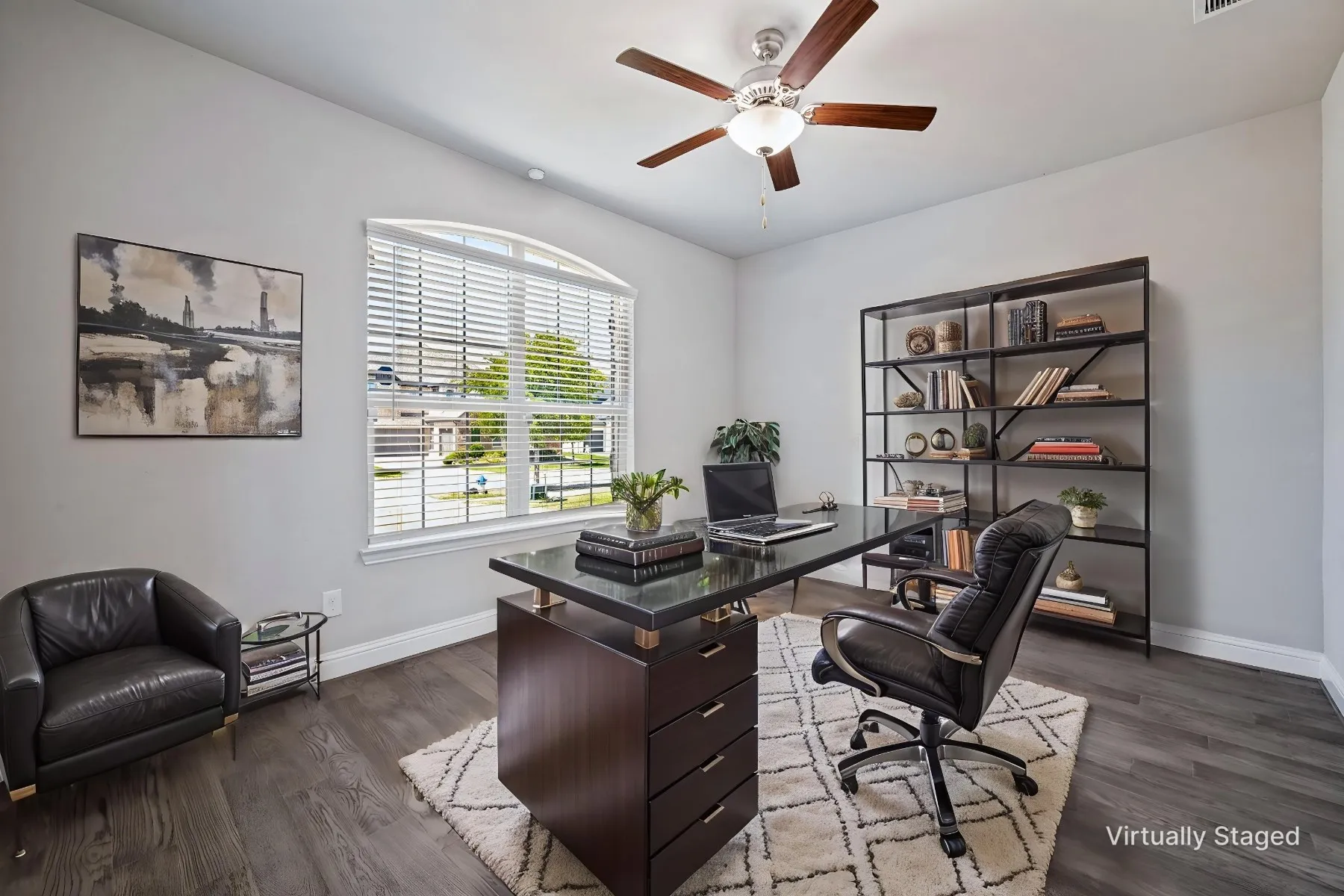 Wood-finish flooring, light grey wall paint, and a multi-speed ceiling fan with integrated lighting