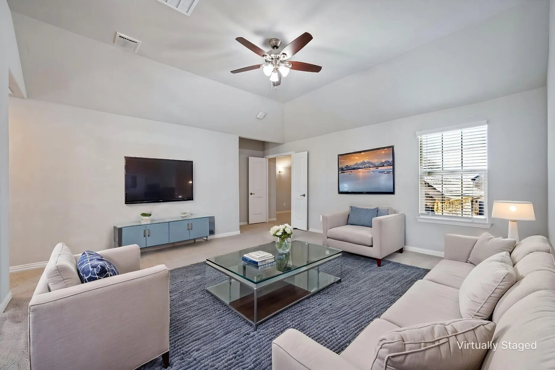 Vaulted ceiling with a ceiling fan, window with blinds, and light-colored carpeting
