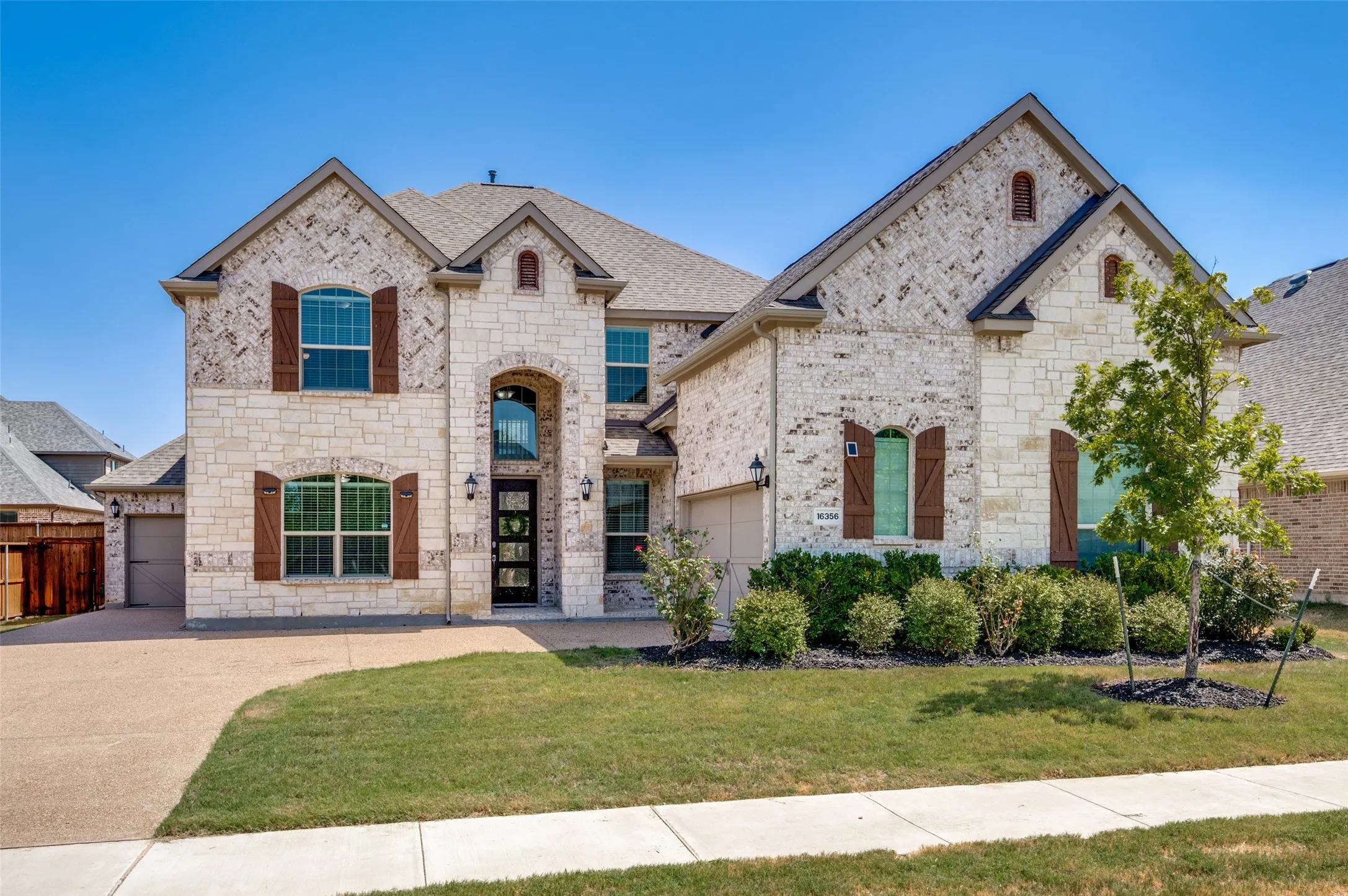 Stone and brick facade with decorative shutters