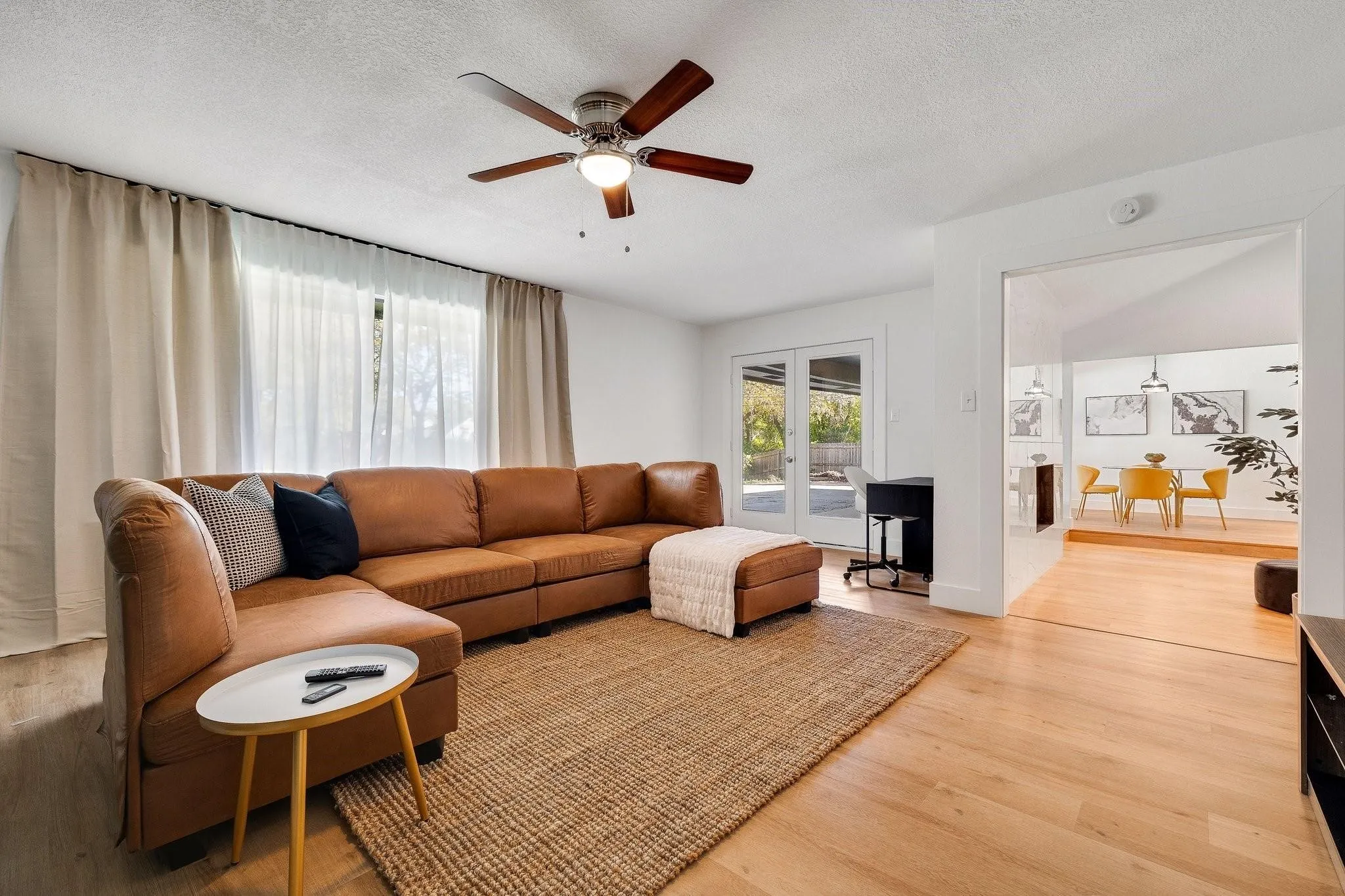 Hardwood-style flooring, ceiling fan with integrated lighting, glass French doors, and recessed entryway