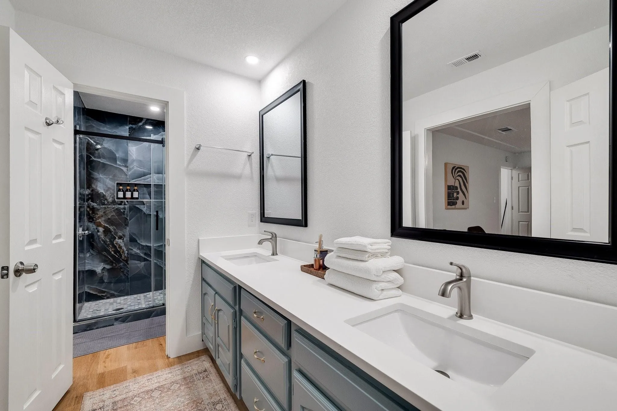 Dual vanity with white countertops, undermount sinks, and brushed nickel fixtures