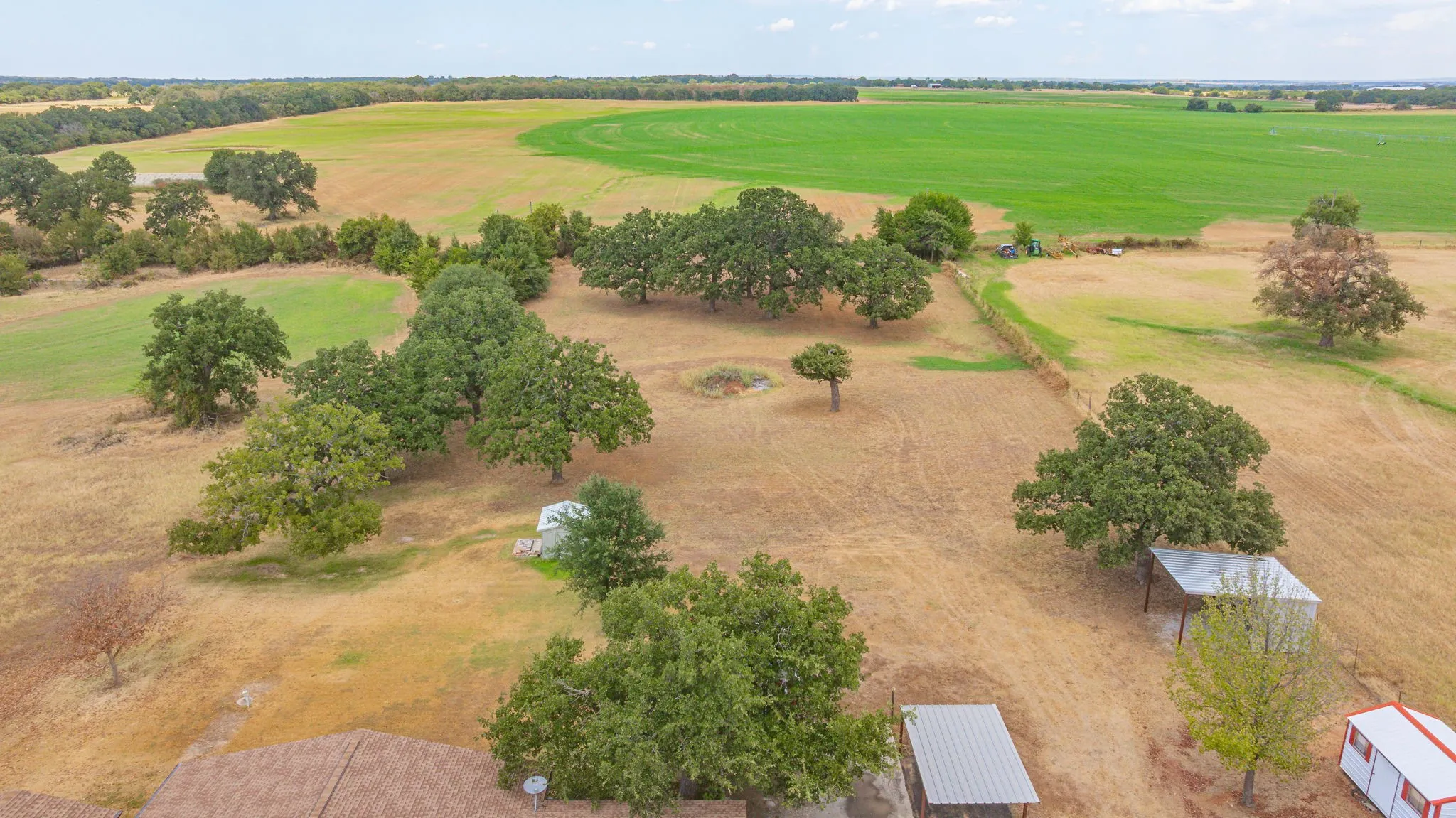 Expansive rural property featuring mature trees and open fields