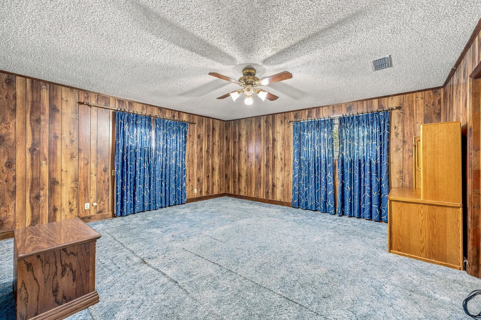 Wood-panel walls with textured ceiling