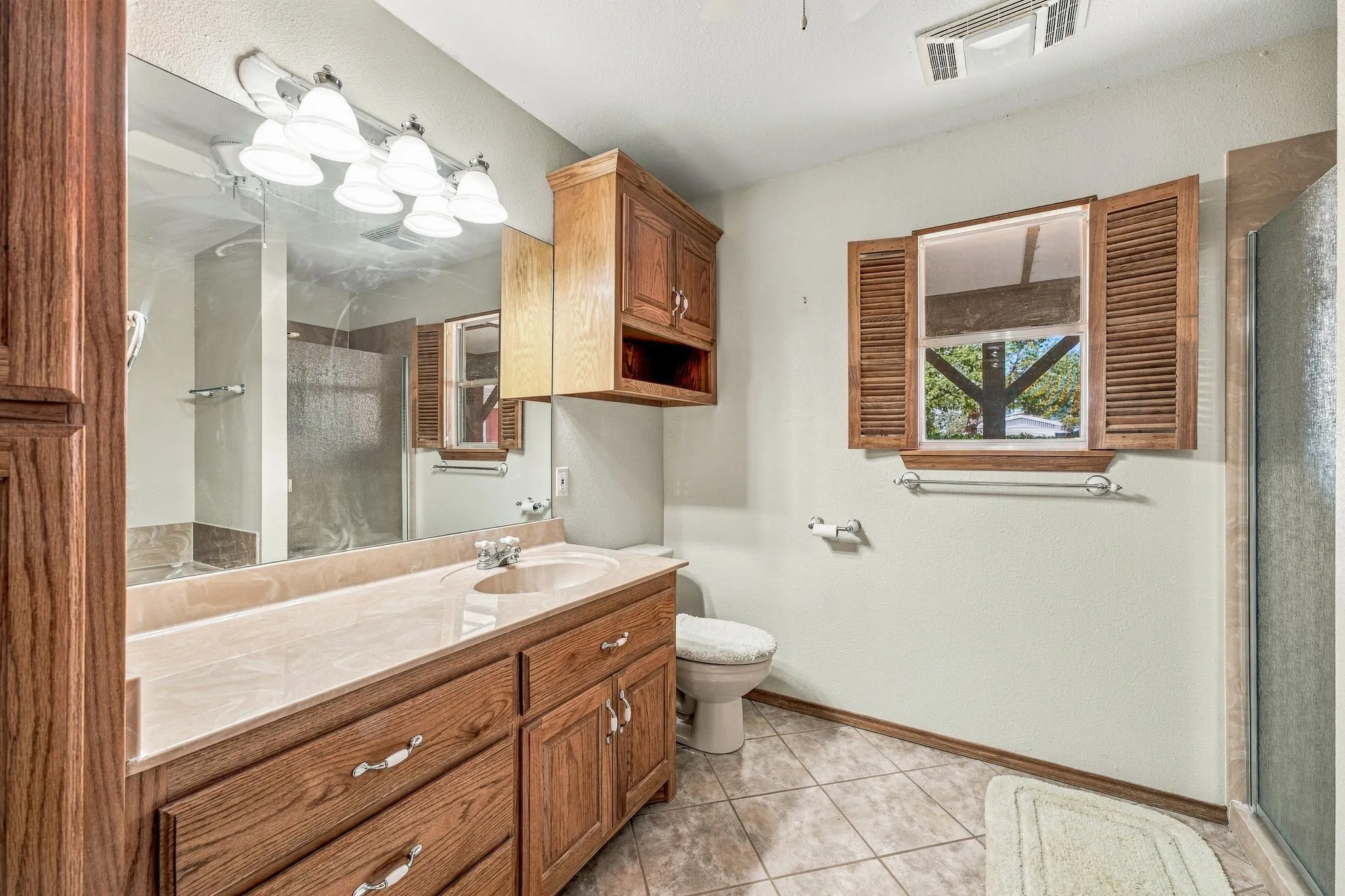 Wood-finish vanity with an integrated basin and a neutral countertop
