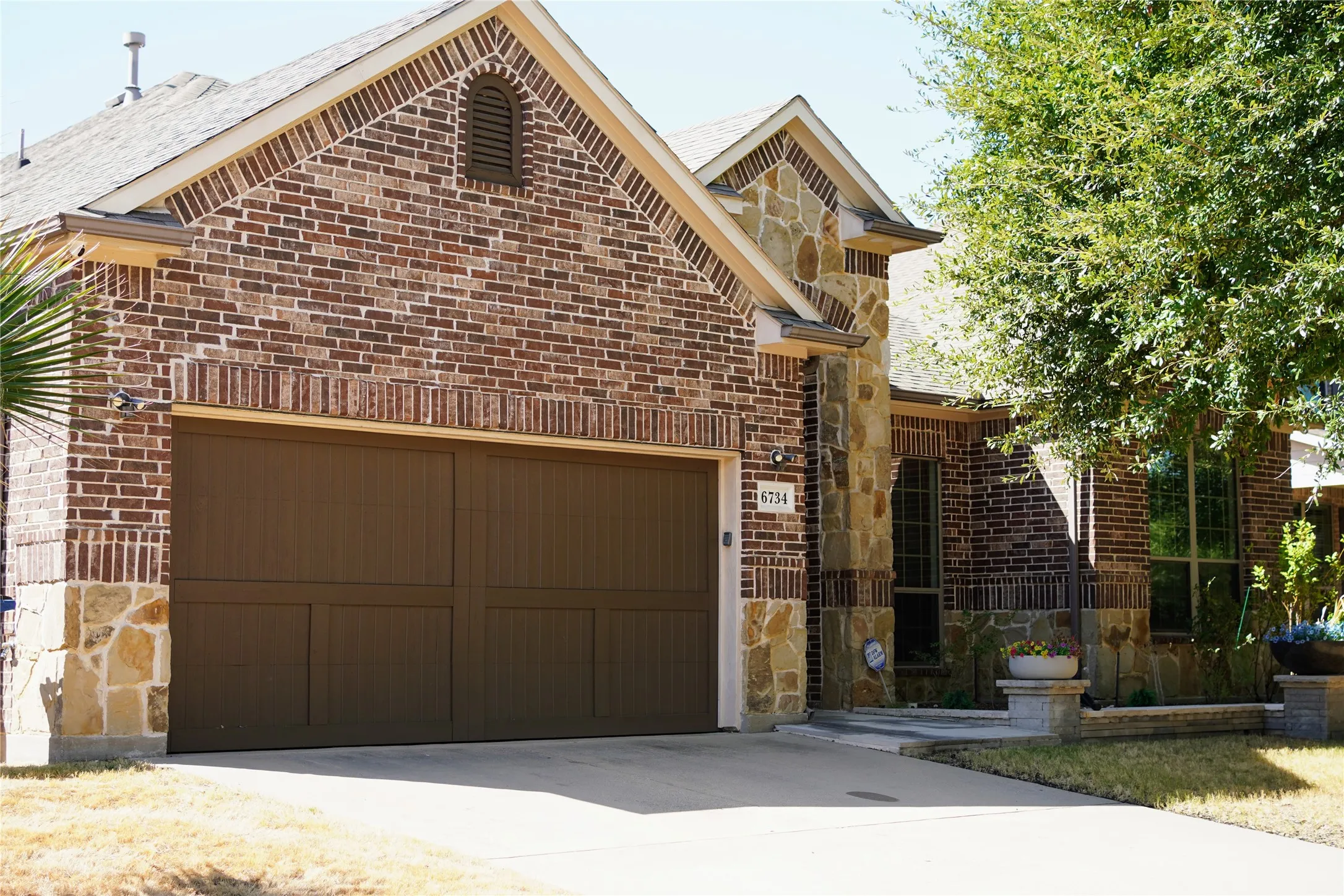 Brick and stone exterior with a two-car garage