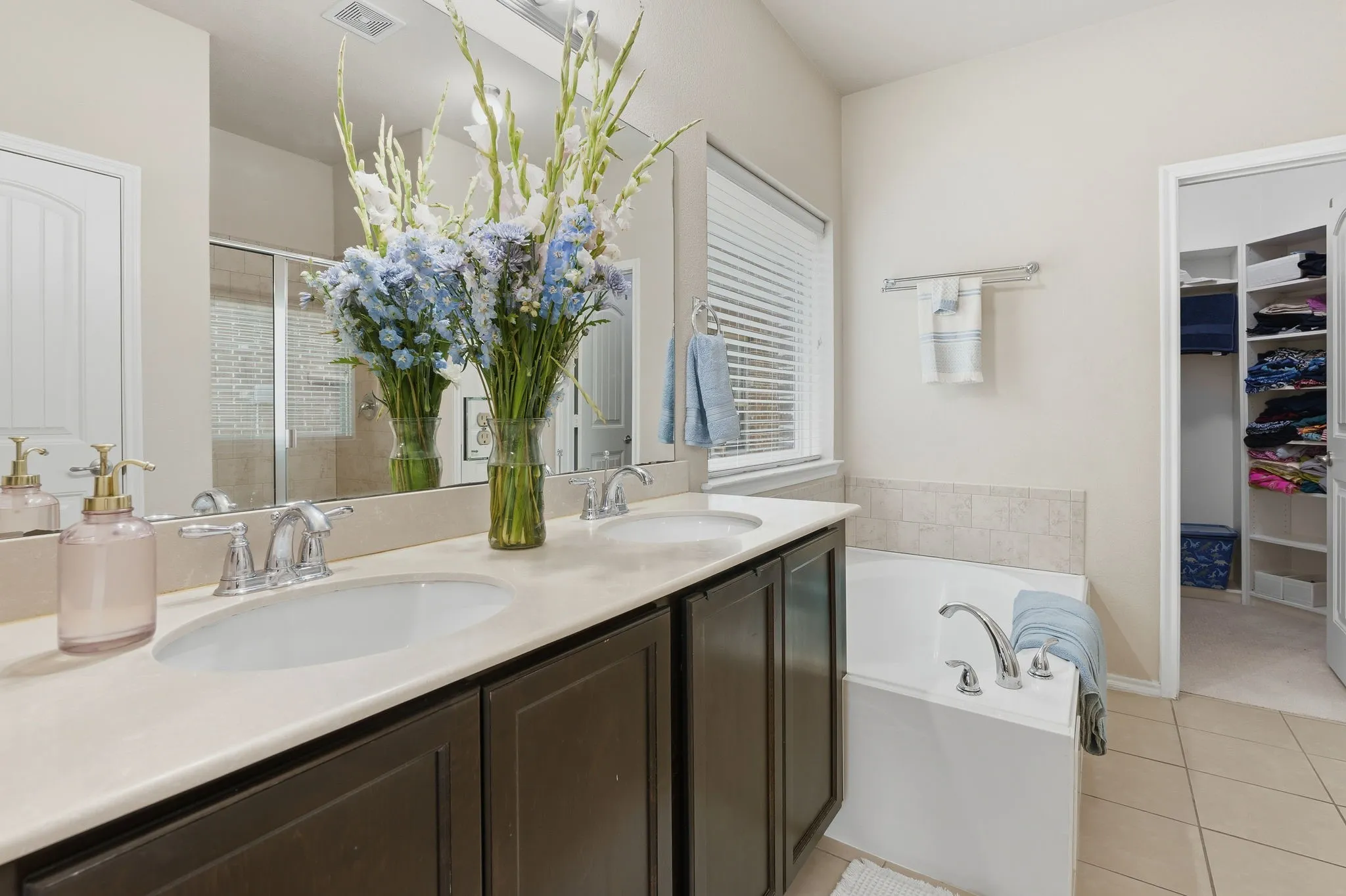 Dual vanity with undermount sinks, chrome fixtures, and light-toned countertop
