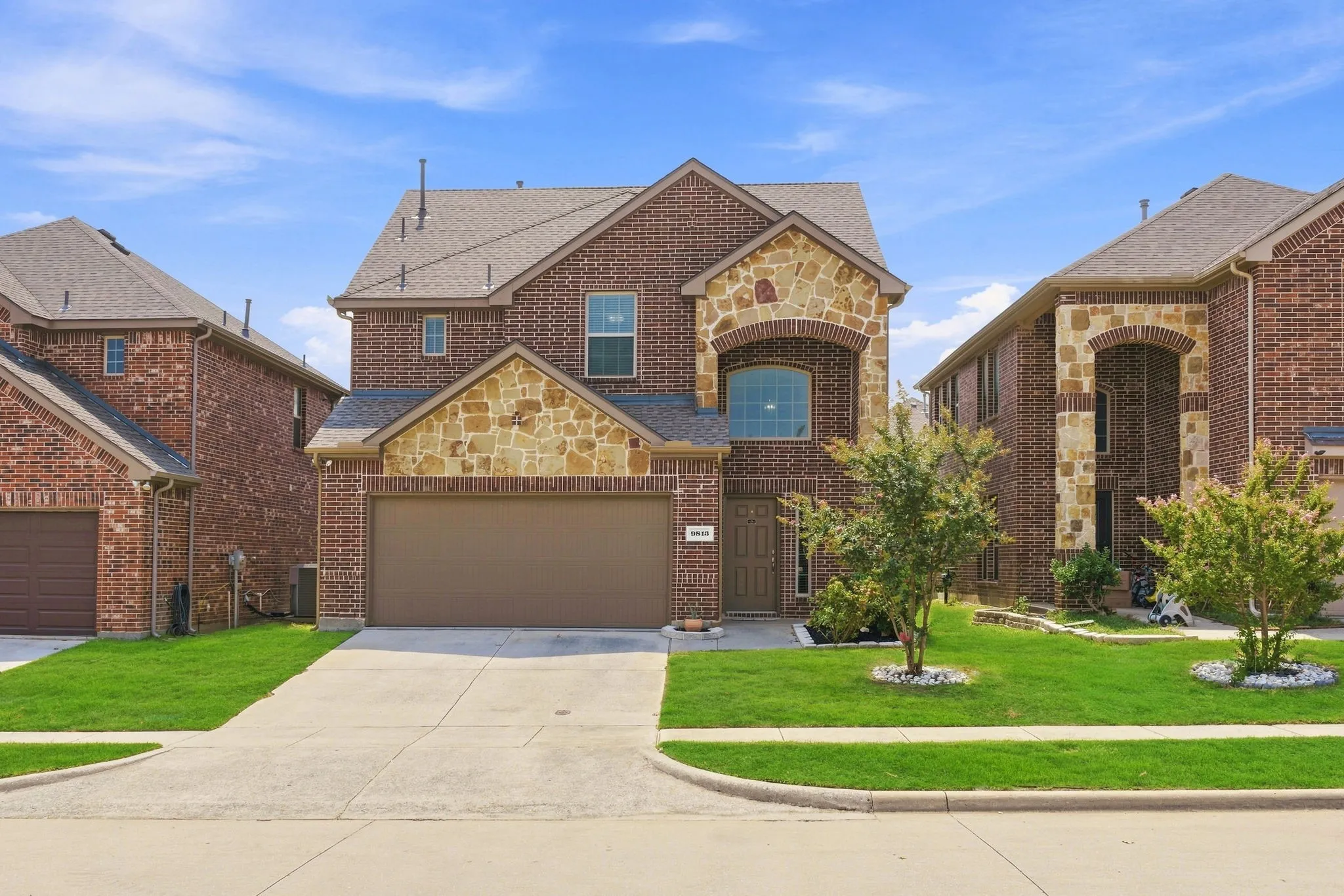 Brick and stone veneer exterior with an arched entry