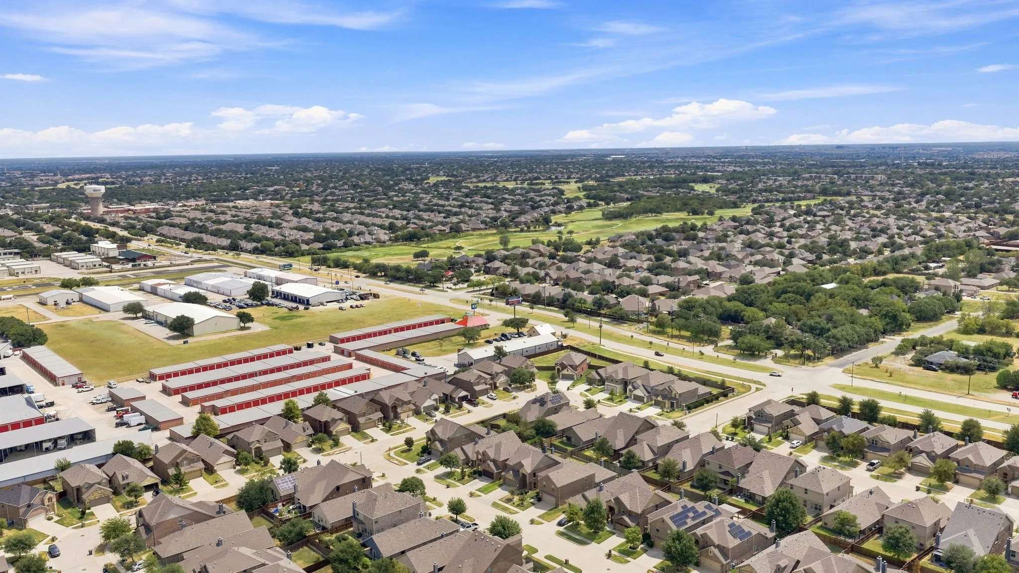 Expansive neighborhood showcasing residential properties with varied rooflines