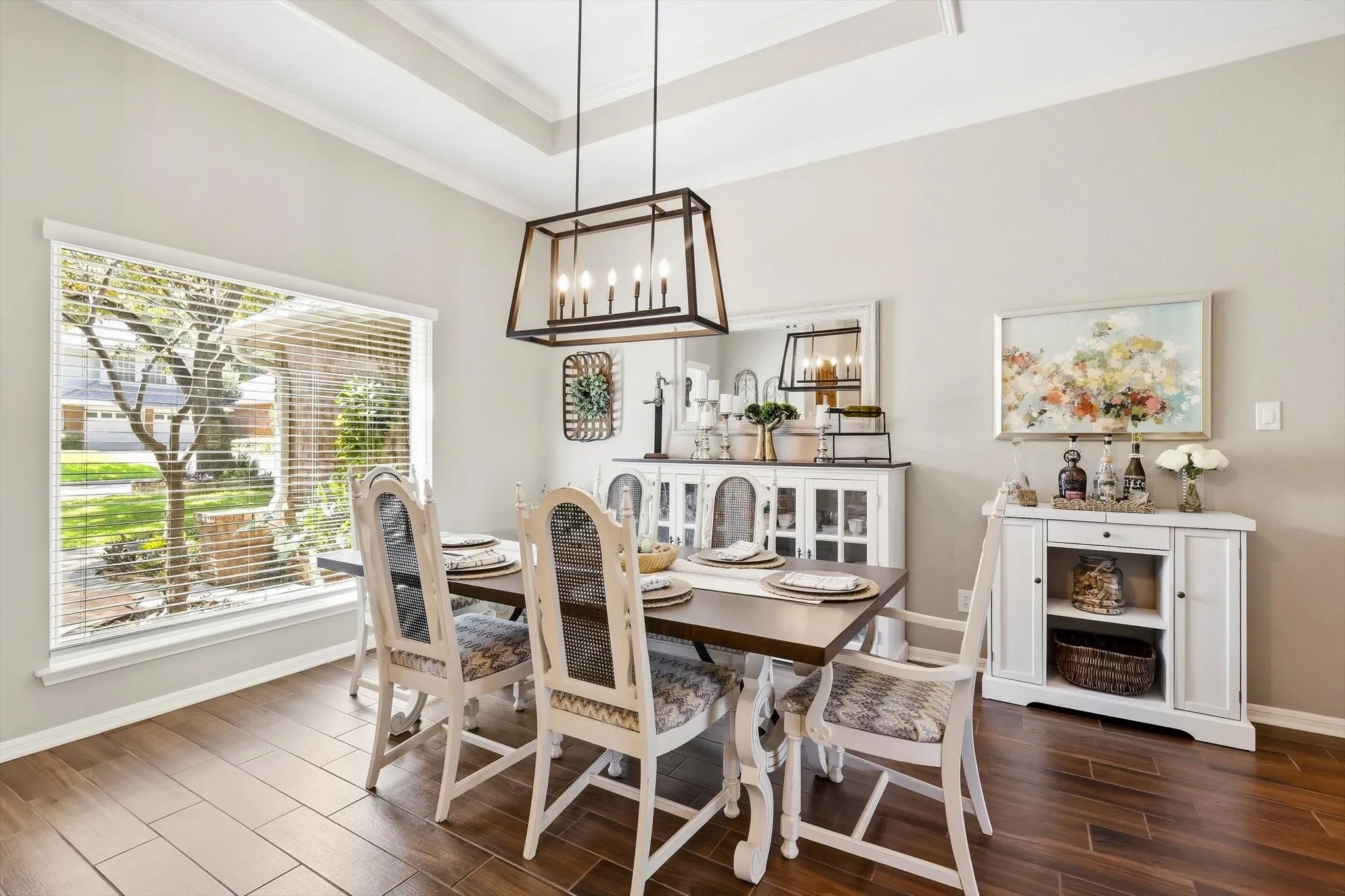 Recessed ceiling, wood-finish flooring, large picture window, and contemporary chandelier