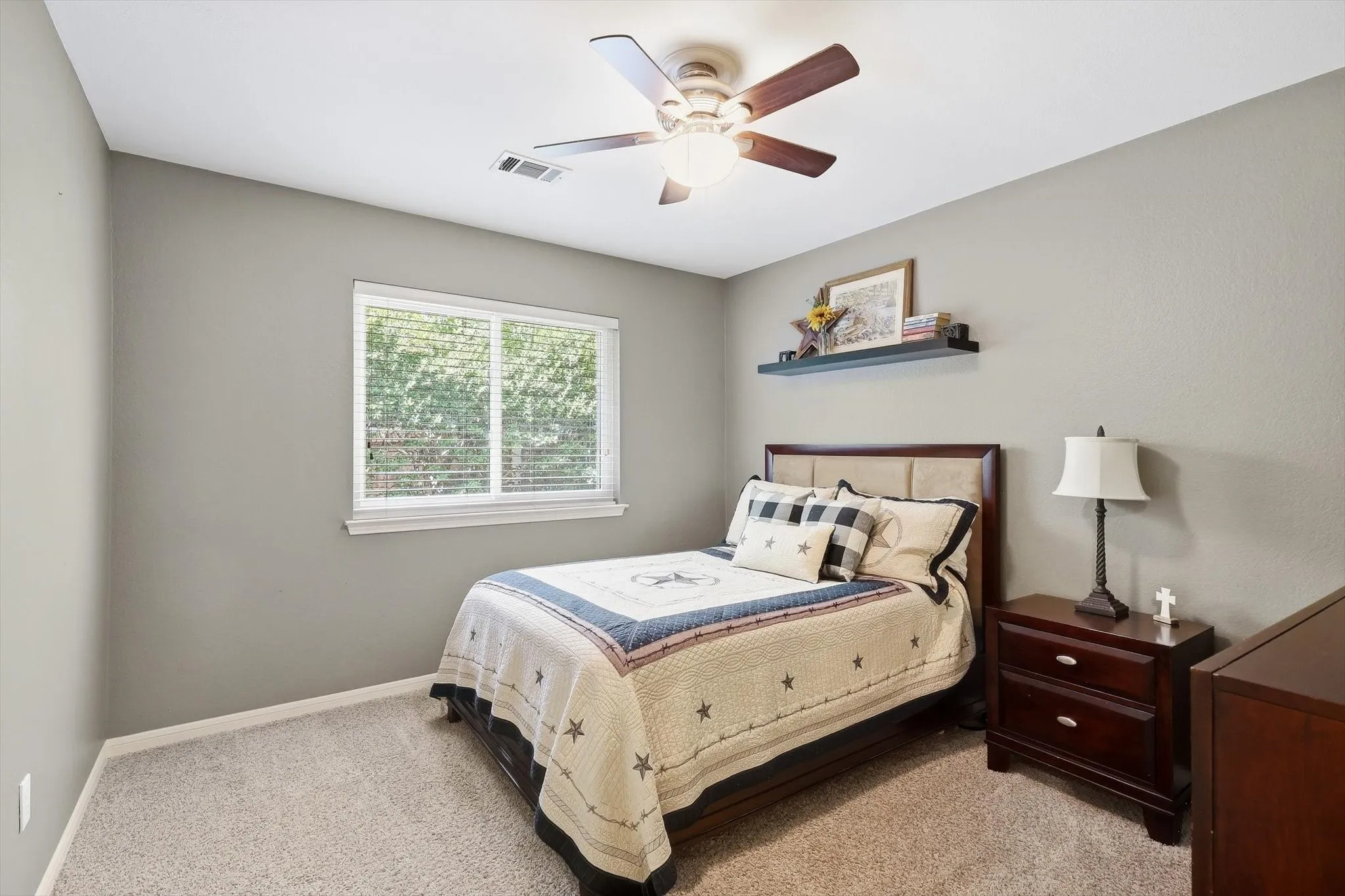Recessed lighting, ceiling fan with light fixture, window with blinds, plush carpet flooring, and a floating wall shelf