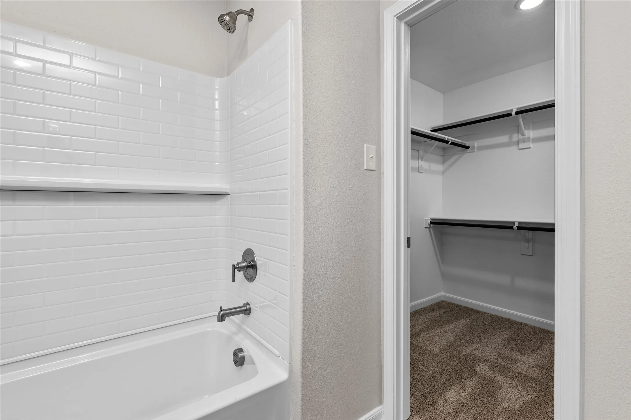 Bathroom featuring shower / bath combination and a walk in closet