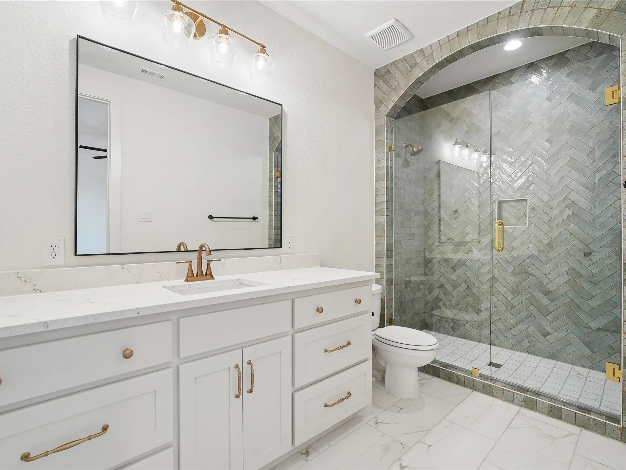 White double vanity with a light-colored countertop and undermount sink