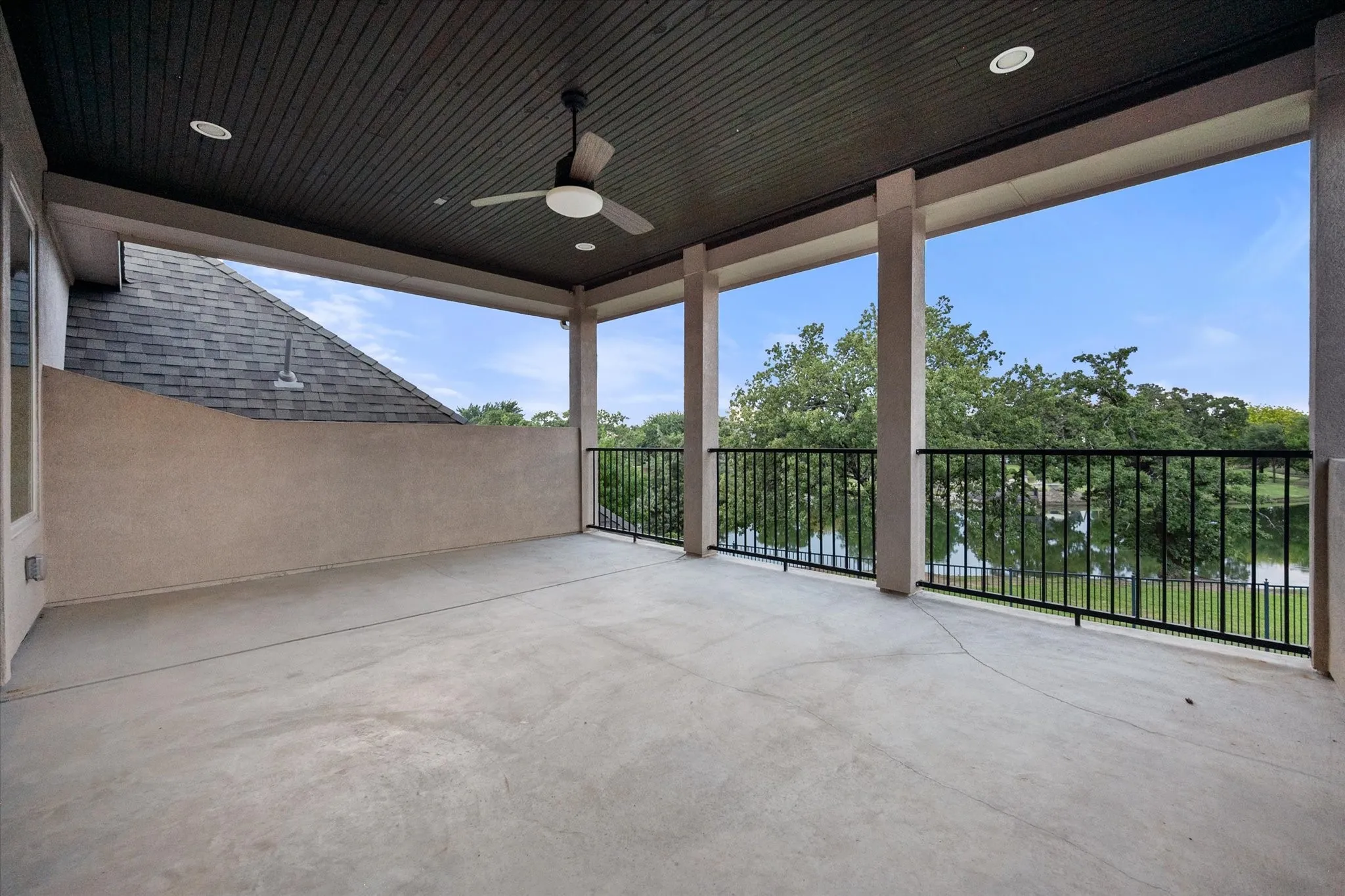 Spacious covered patio with concrete flooring, recessed lighting, and a ceiling fan