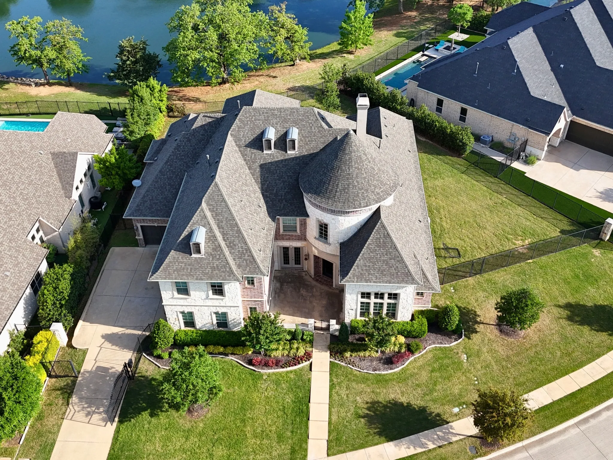 Stone and brick exterior with a turret, dormer windows, and a multi-level roofline