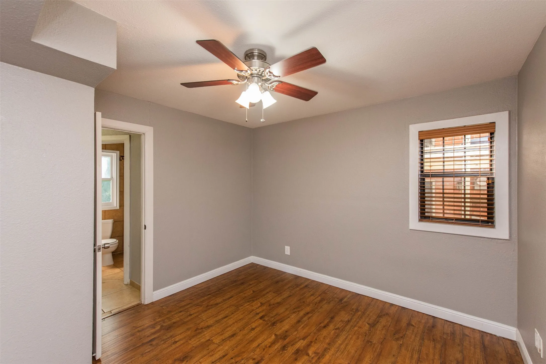 Unfurnished room with ceiling fan and hardwood / wood-style floors