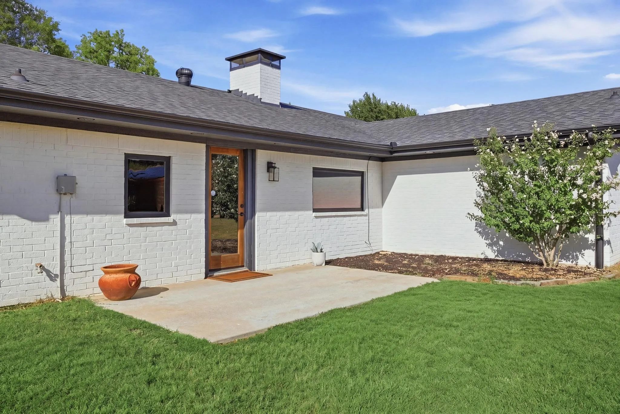 Existing back patio - a blank slate for your outdoor living dreams with lots of backyard space.