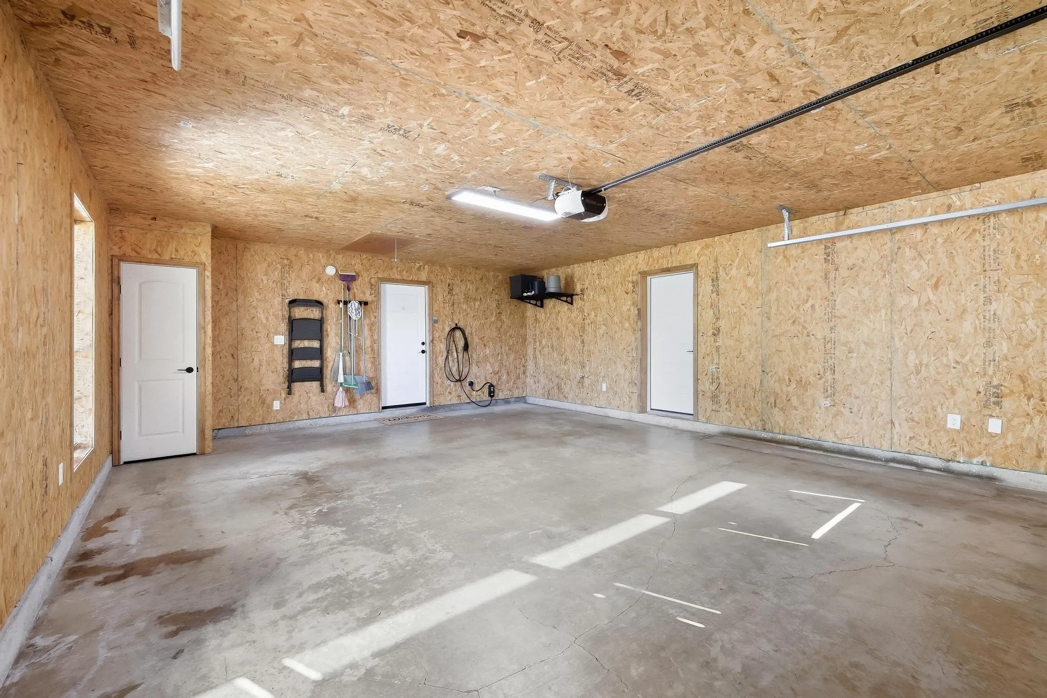 Two-car deep garage with charging station for EV.
