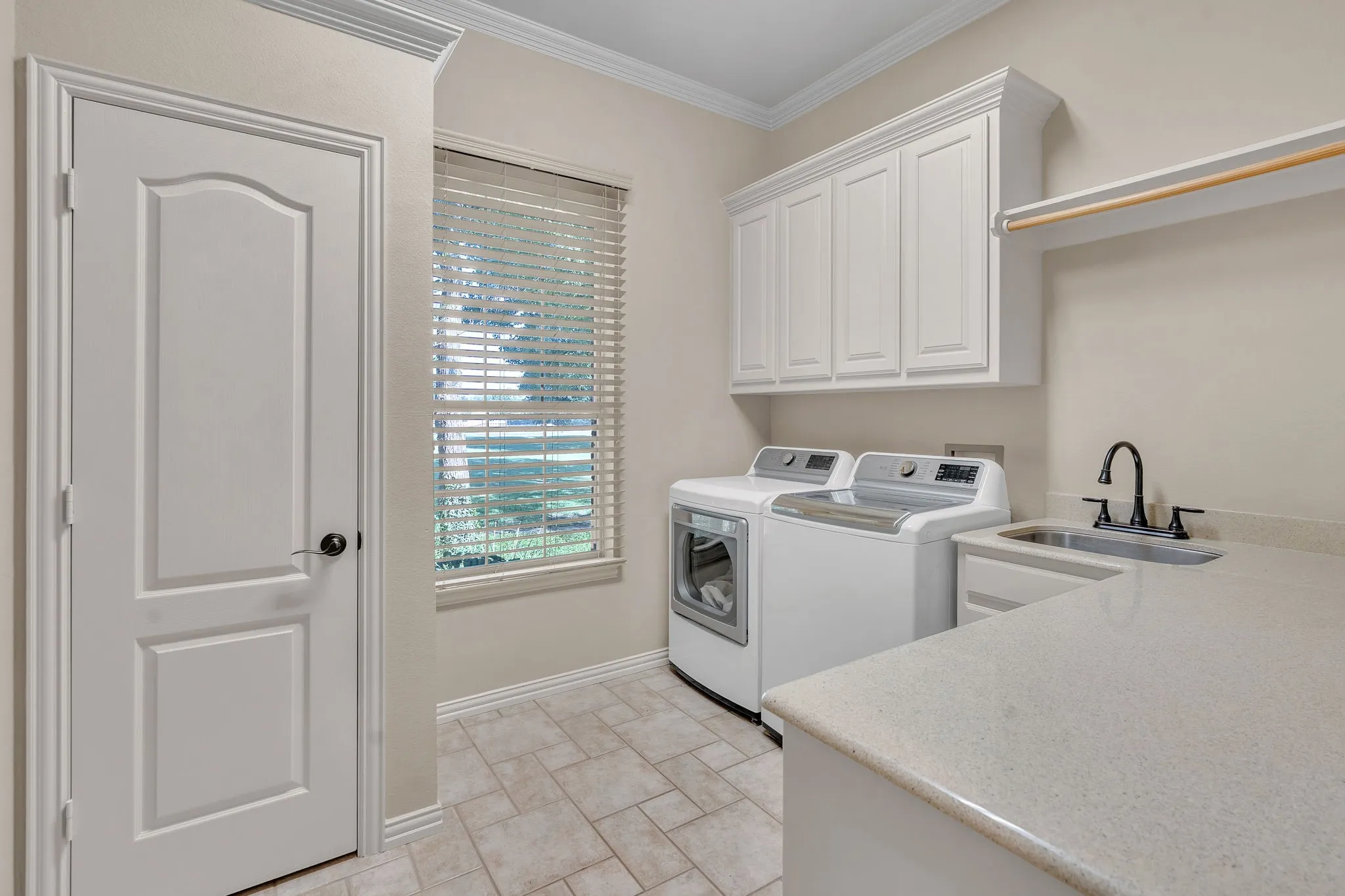 Large Laundry with built in sink and lots of storage.
