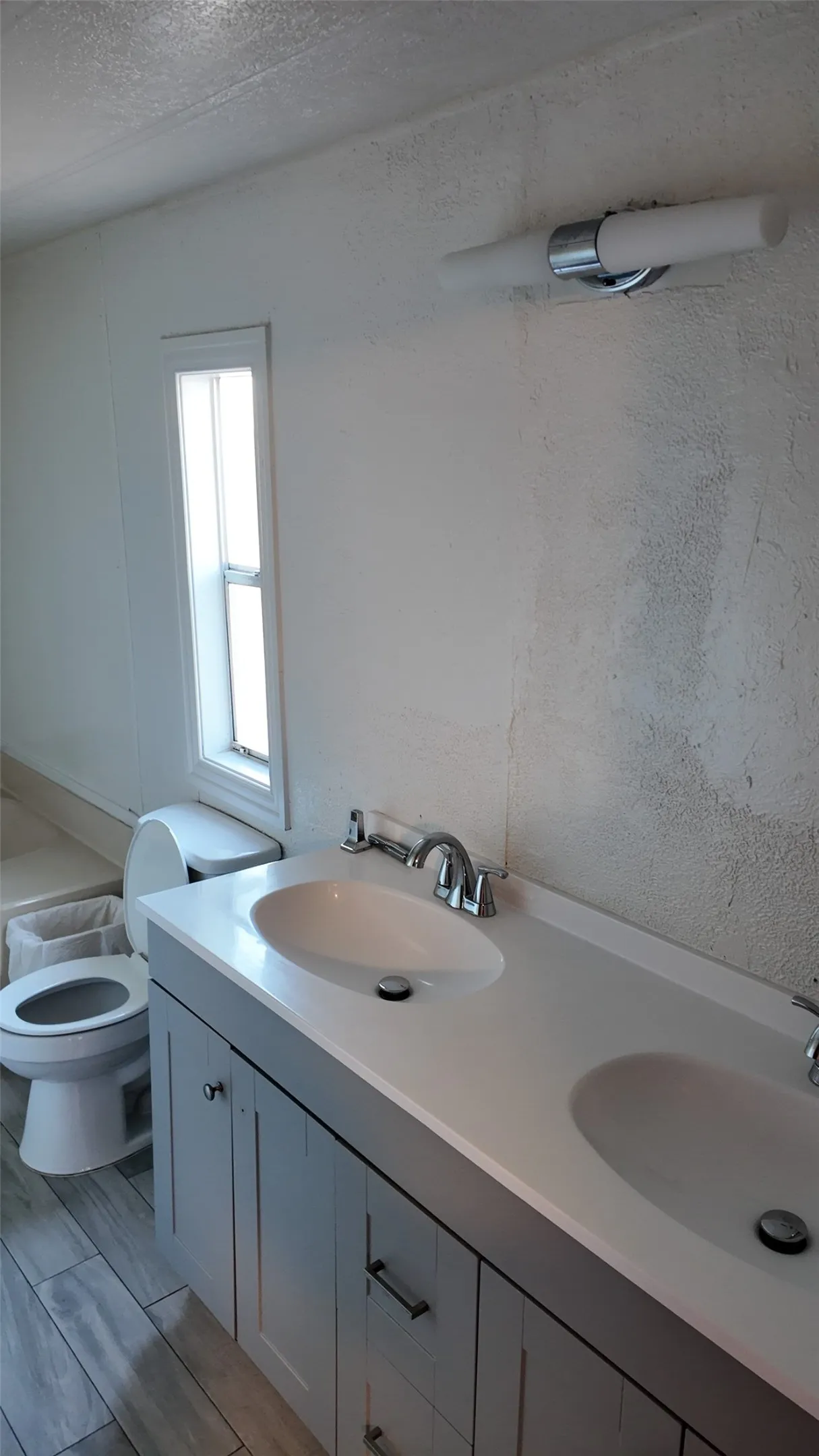 Dual vanity with integrated sinks, chrome fixtures, and shaker-style cabinetry