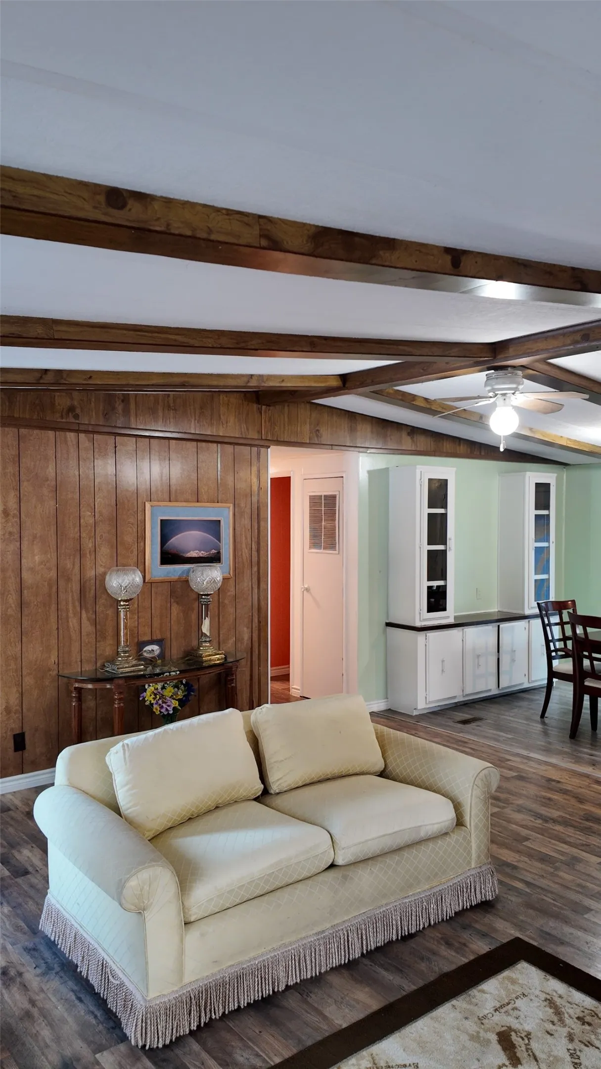 Exposed wood-finish ceiling beams, wood-finish paneling, and wood-finish flooring