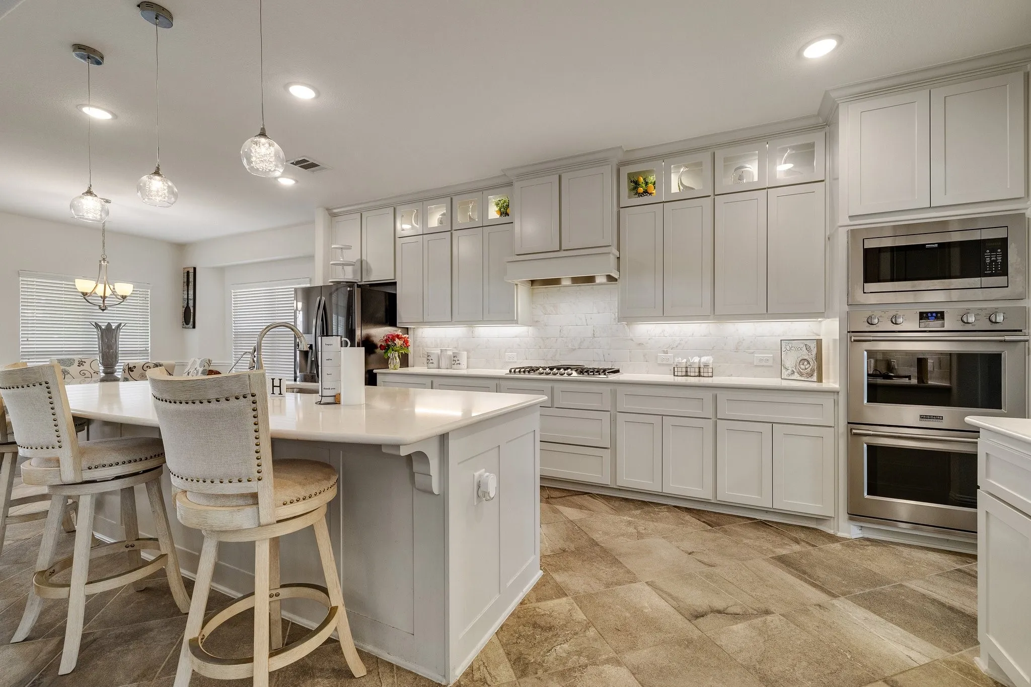 Kitchen: Abundant cabinetry, stainless appliances, double ovens and expansive counter space make this kitchen as functional as it is beautiful.