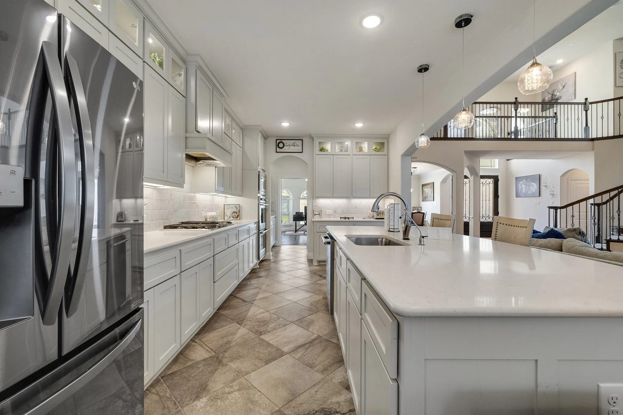 Kitchen & Island: The oversized island provides plenty of prep space and casual seating while keeping everyone connected.