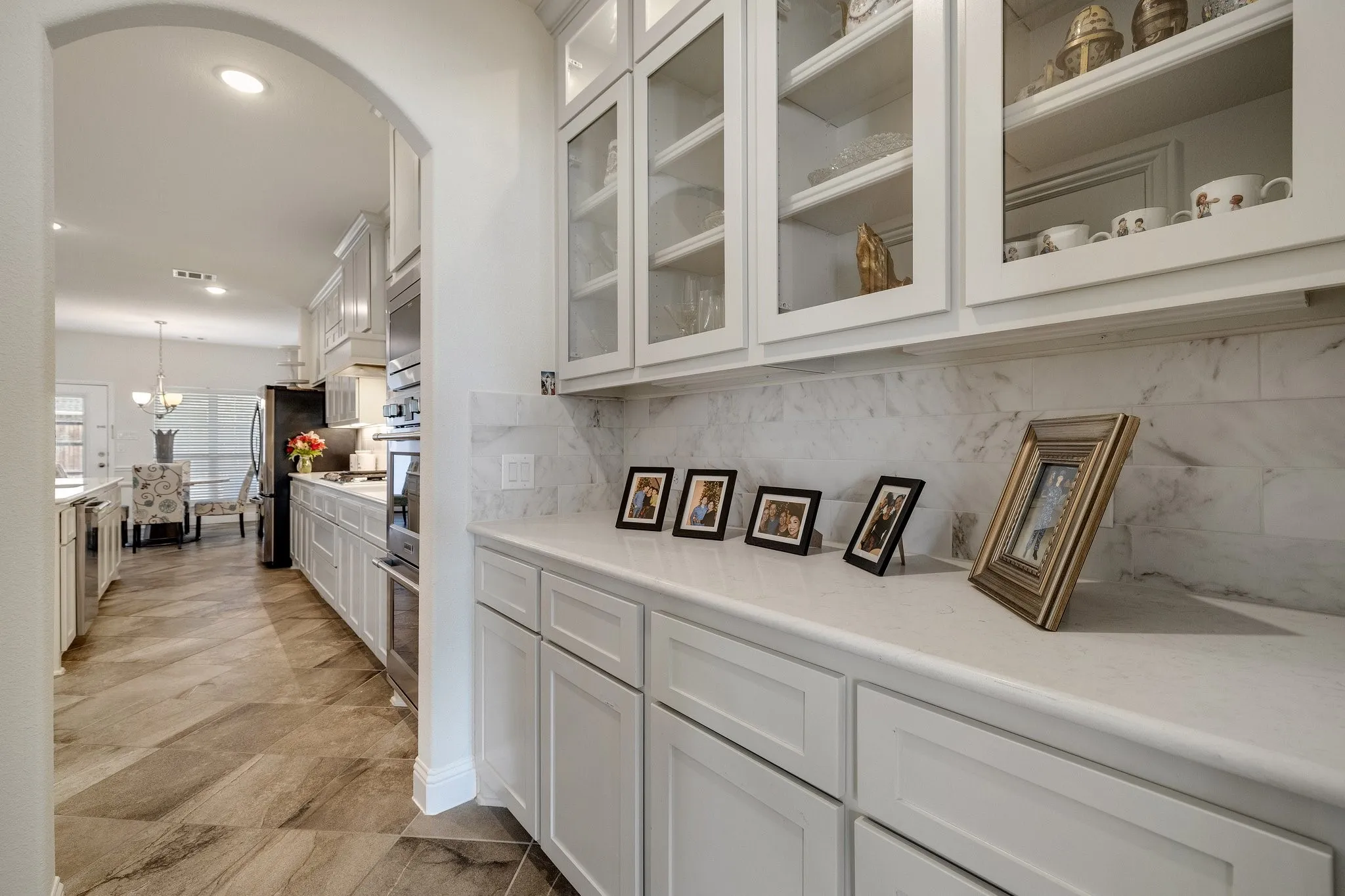 Butler’s Pantry / Coffee Bar: Beautiful built-in cabinetry and generous counter space create the perfect coffee bar or serving area between the kitchen and dining spaces.