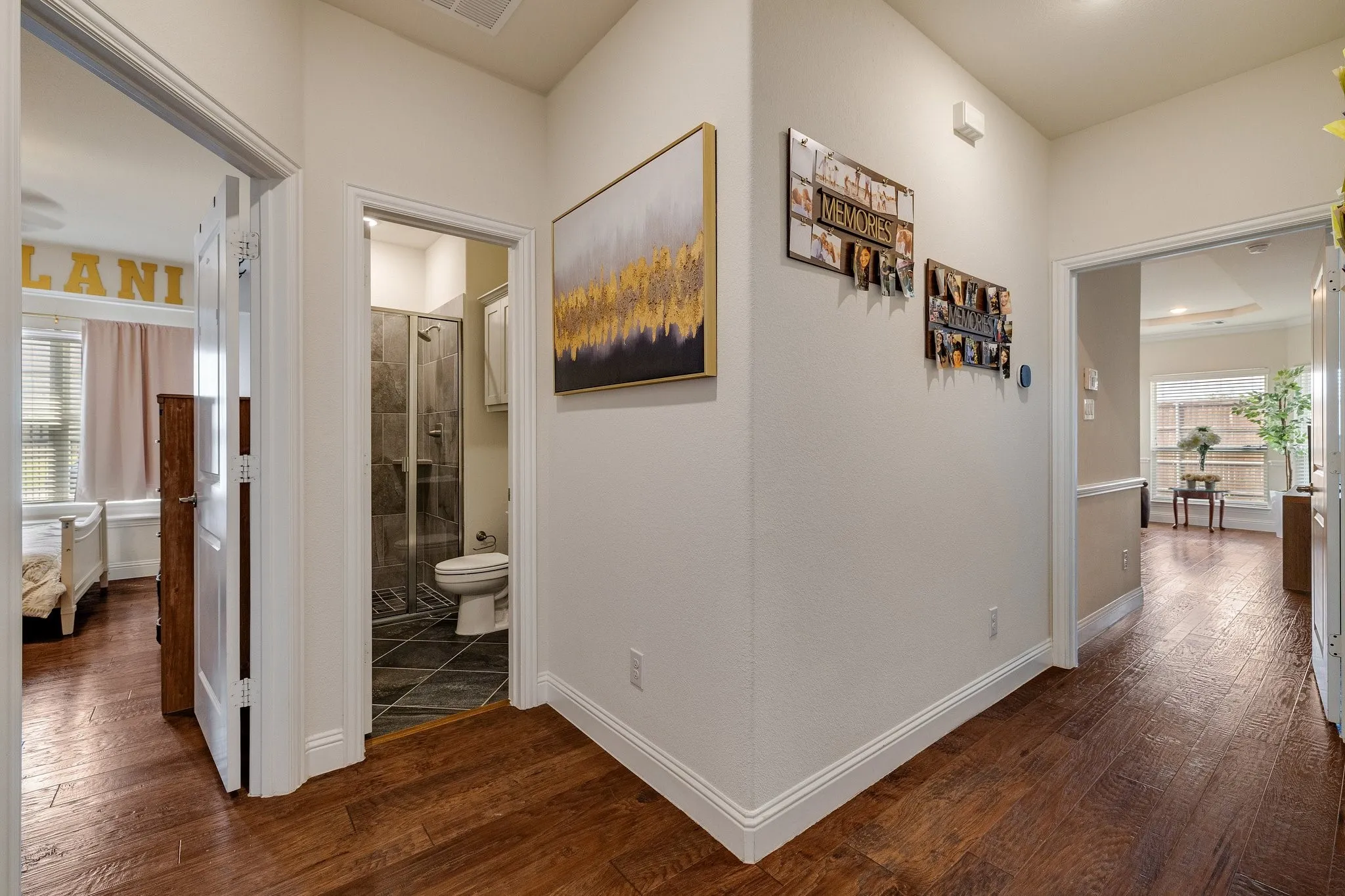 Wood-finish flooring throughout, white trim, and light-colored walls