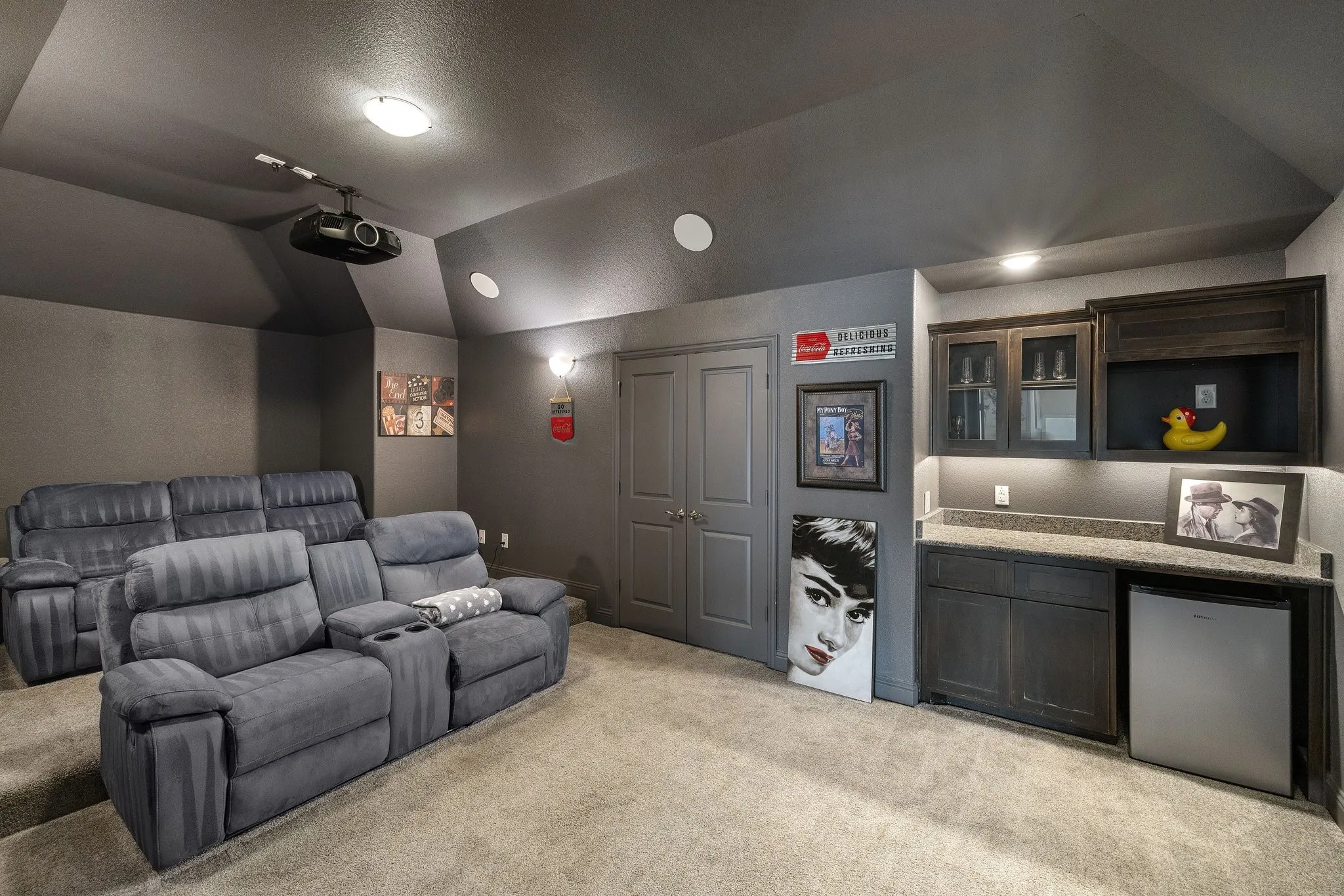 Built-in wet bar with wood cabinetry, under-cabinet lighting, and a compact refrigerator