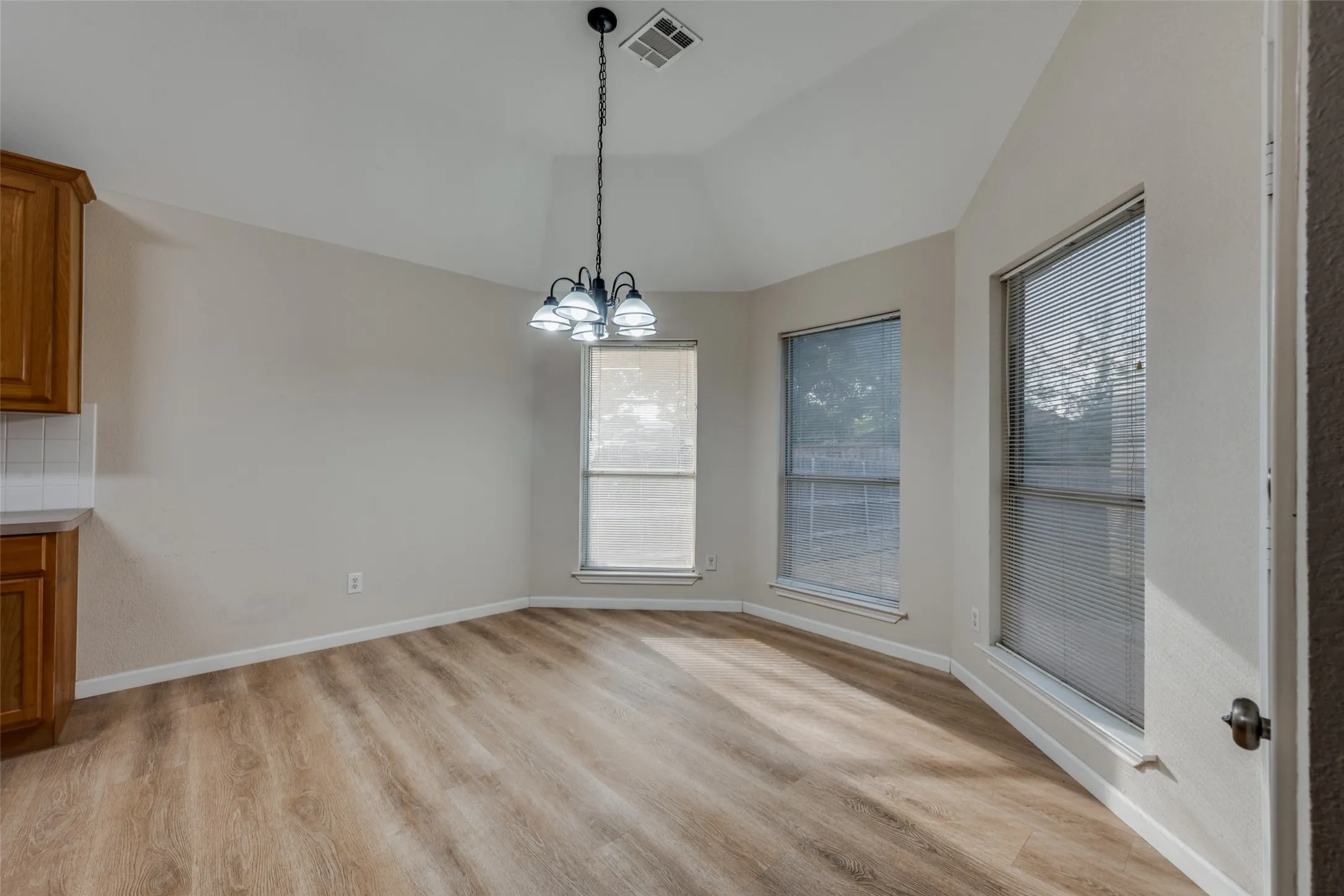 Breakfast area with bay window and view of back yard.