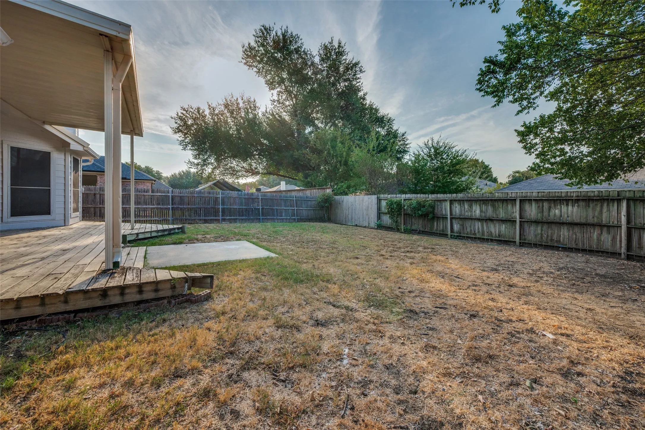 Spacious backyard with covered deck.
