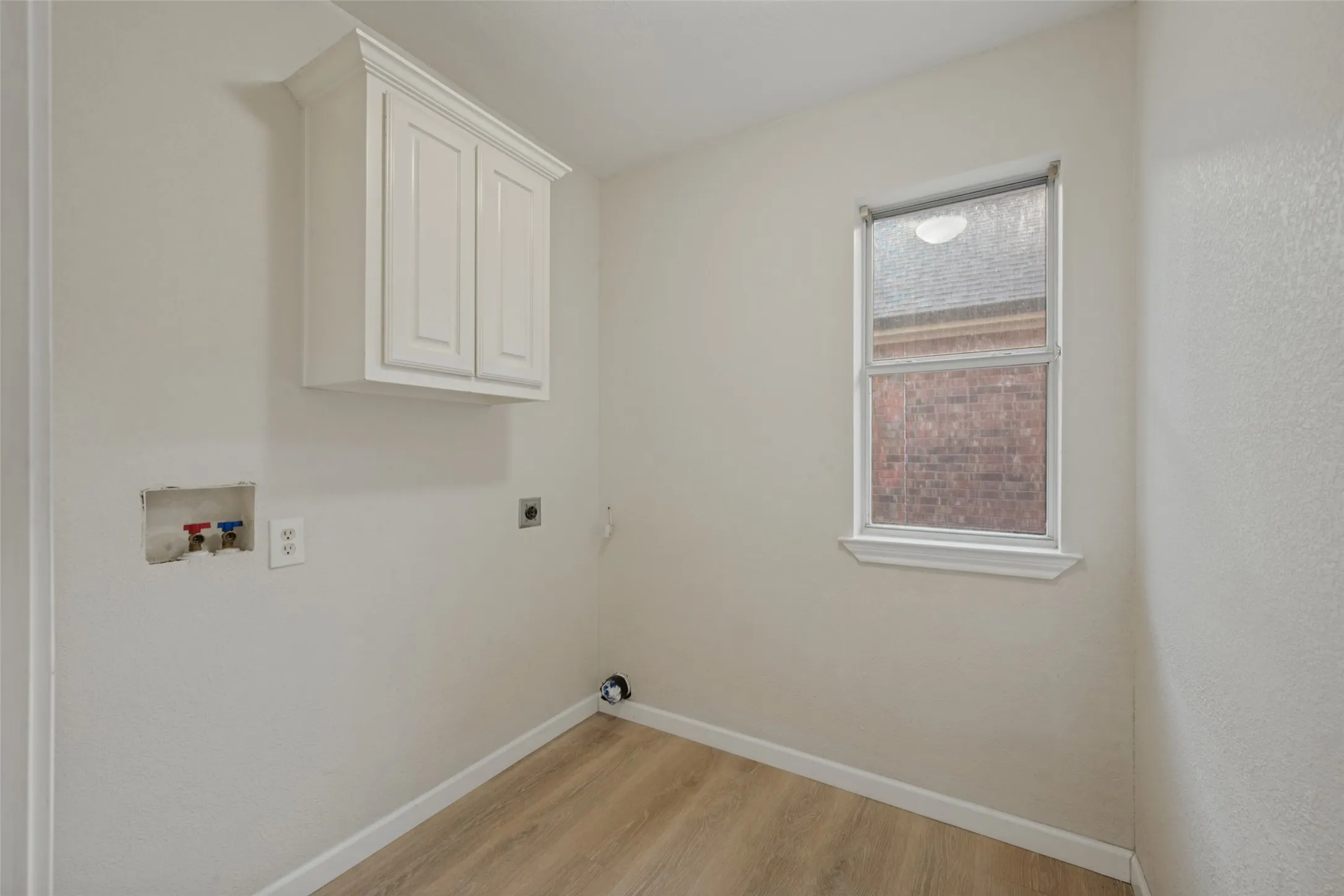 Separate laundry room for full size washer dryer.