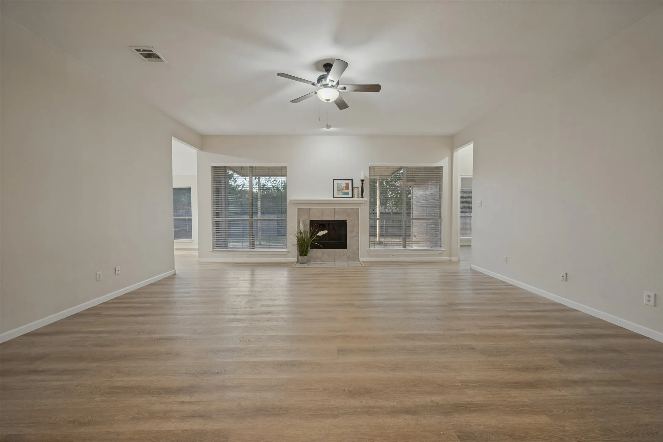 Living room with wood burning fireplace and view of the back yard.