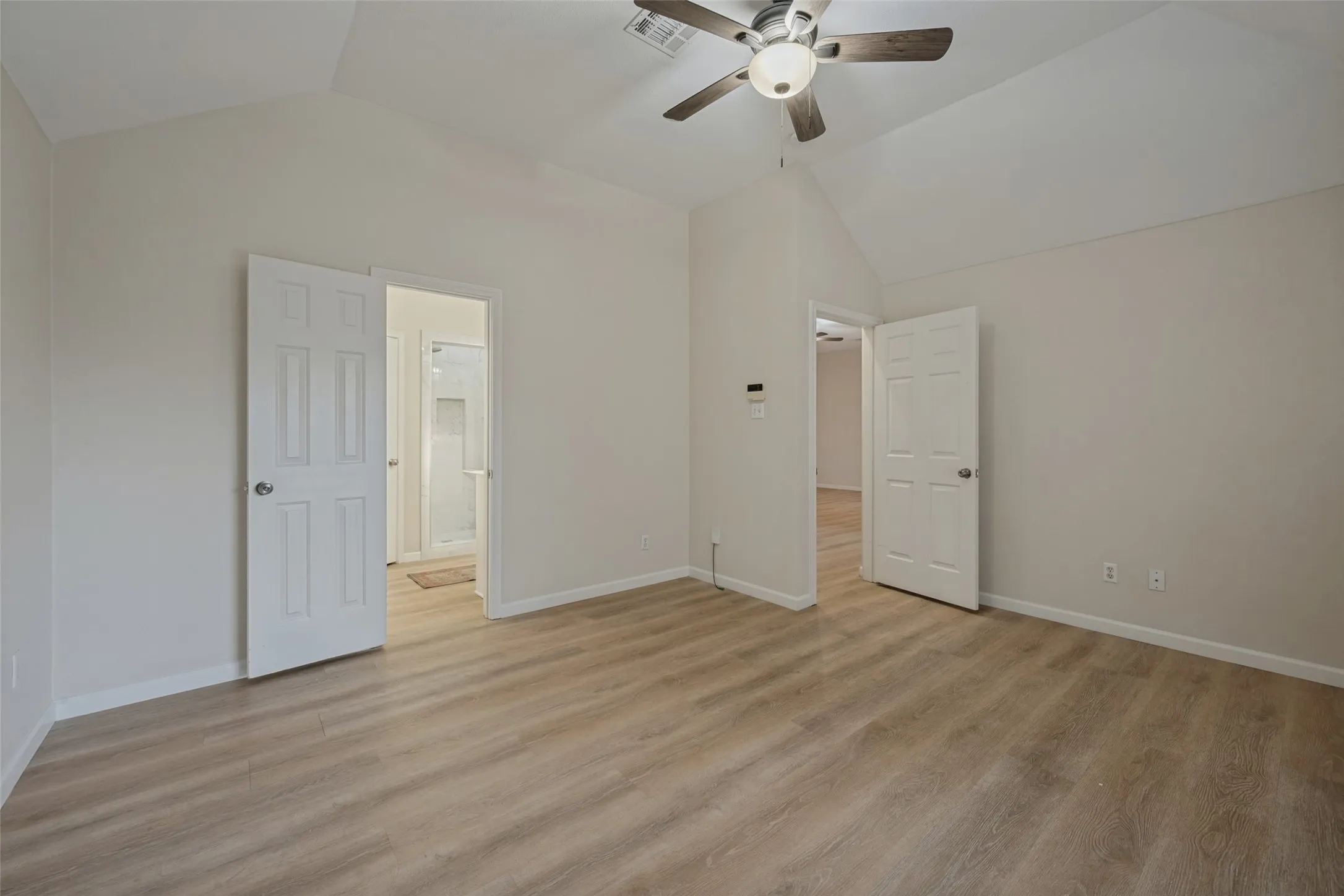 Primary bedroom and entrance to primary bath.