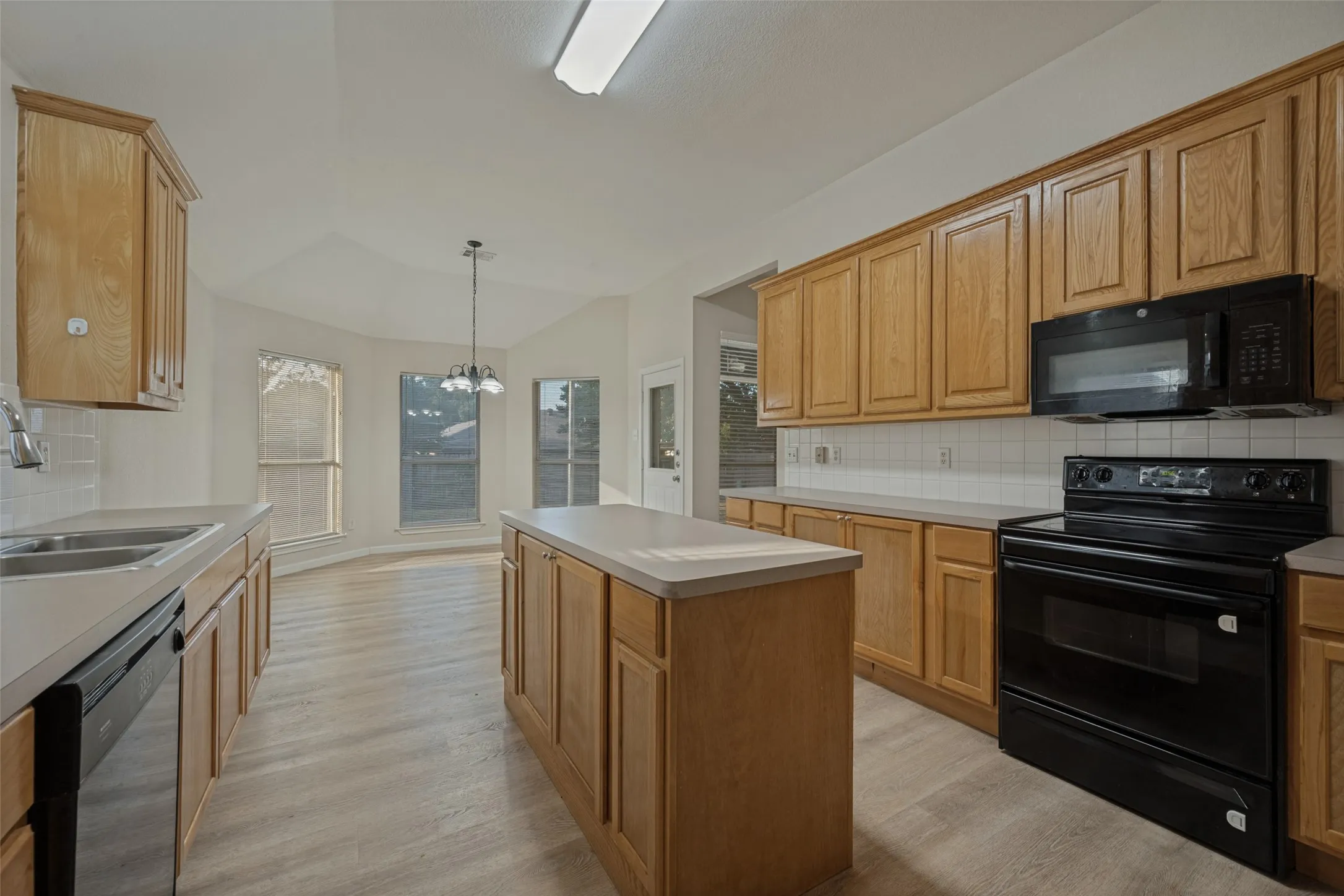 Kitchen with island and plenty of counter space and view to of breakfast area.