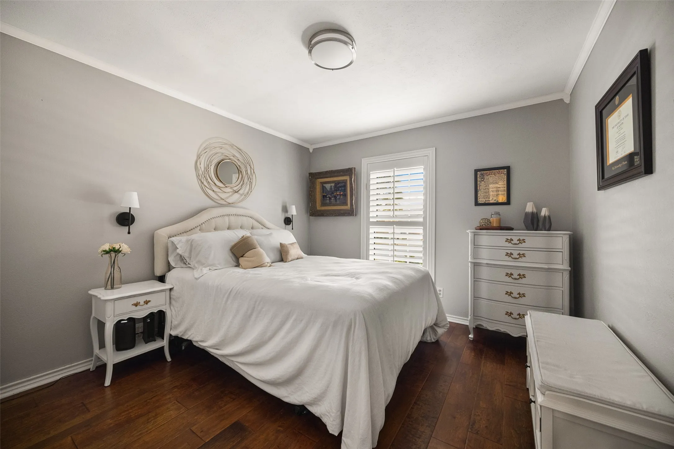 Wood-finish flooring, neutral wall color, crown molding, plantation shutters, and a ceiling-mounted light fixture