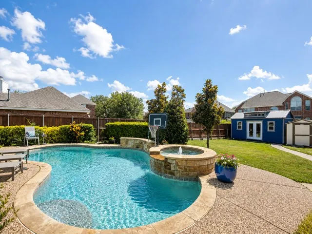 Oversized deep lot with large grassy area, 3 storage buildings, plus pool/spa and a long driveway with gate.