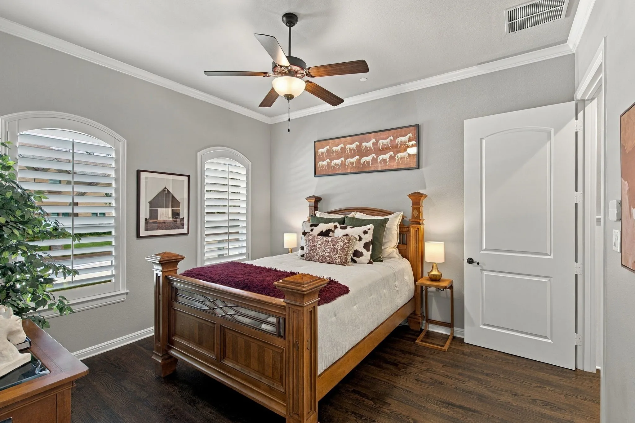 Rich hardwood floors, plantation shutters and graceful arched windows add character, while a private en-suite bath and walk-in closet provide the comfort and convenience of a true guest suite.