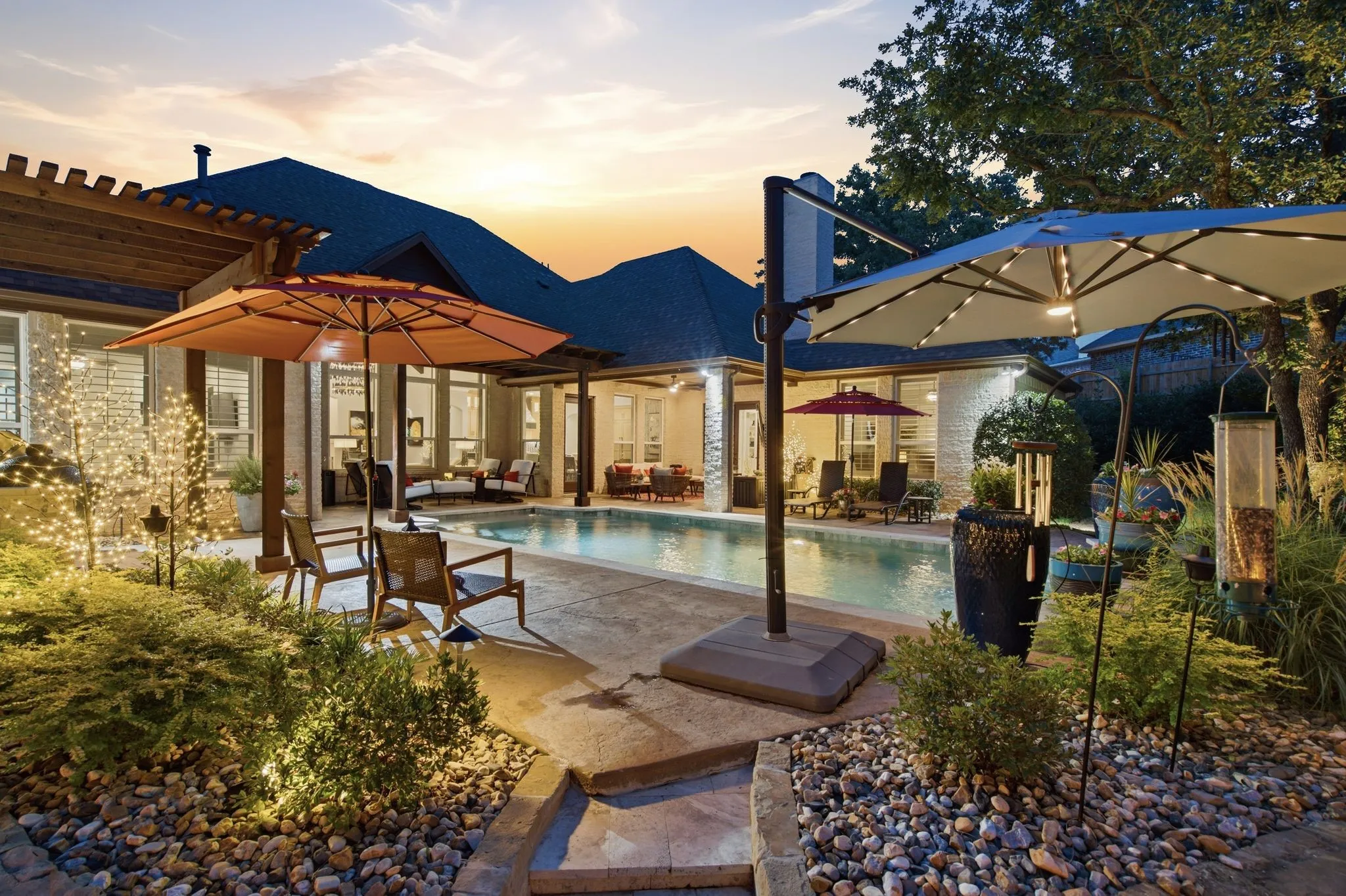 Step outside to a private backyard retreat designed for resort-style living and unforgettable entertaining. The sparkling pool is surrounded by multiple lounging and gathering areas, lush mature landscaping and beautiful landscape lighting, while expansive covered outdoor living creates a seamless extension of the home. Whether hosting a crowd or unwinding at sunset, this backyard feels like a getaway of its own.