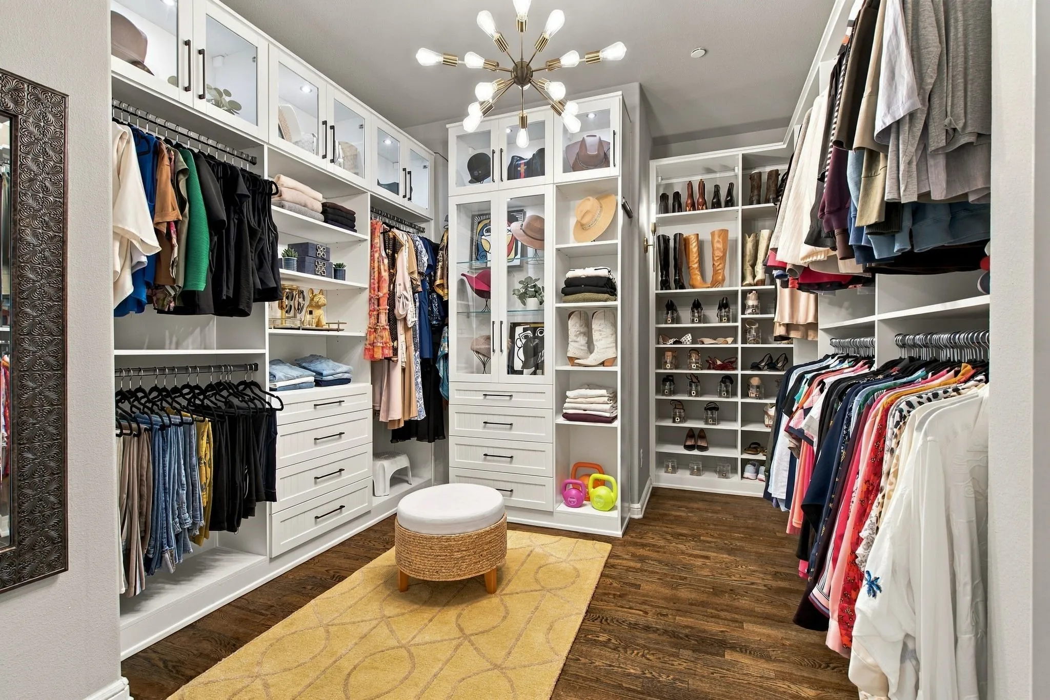 A showpiece in its own right, the spacious primary closet features a custom California Closet organization system designed to maximize both storage and style. Extensive built-ins include glass-front display cabinetry, illuminated shelving, abundant drawers, two valet rods and dedicated shoe and accessory storage—all beautifully finished for a true boutique-inspired dressing experience.